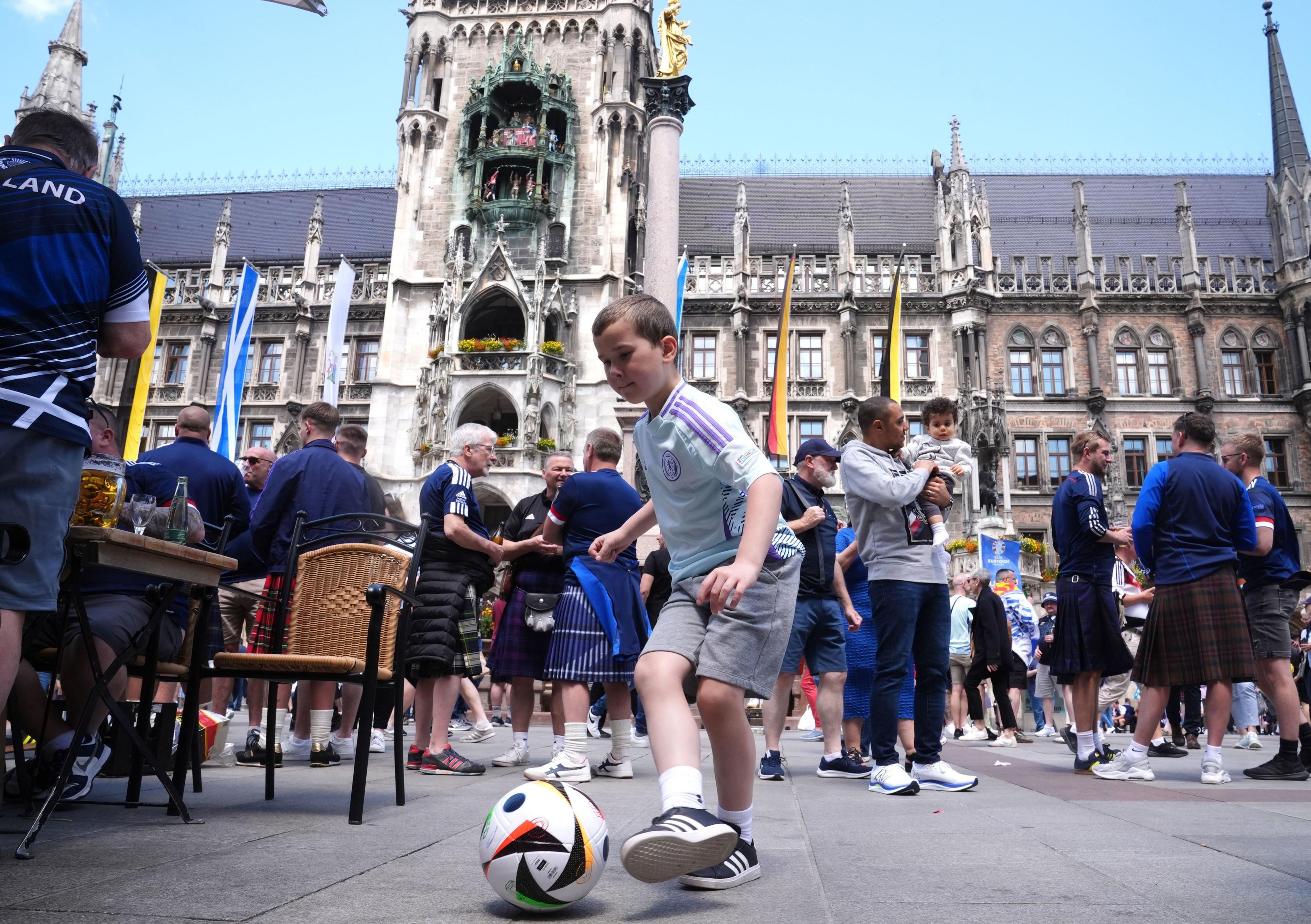 Young boy playing with football