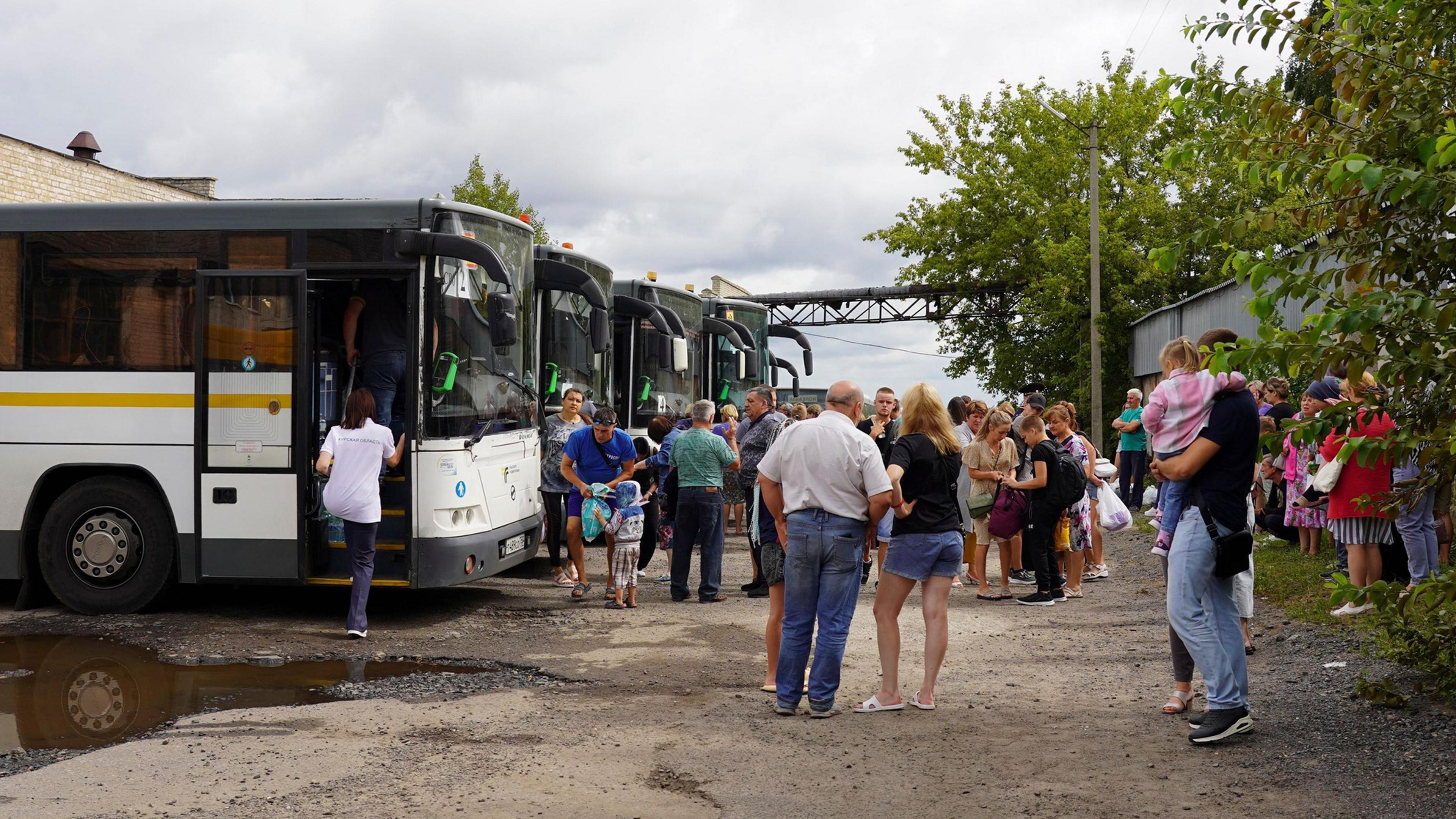 A handout photo made available by the Government of Kursk region of Russia shows people from the border districts of the Kursk region boarding buses to travel to children's camps in the Moscow region, in Kursk, Russia, 09 August 2024.