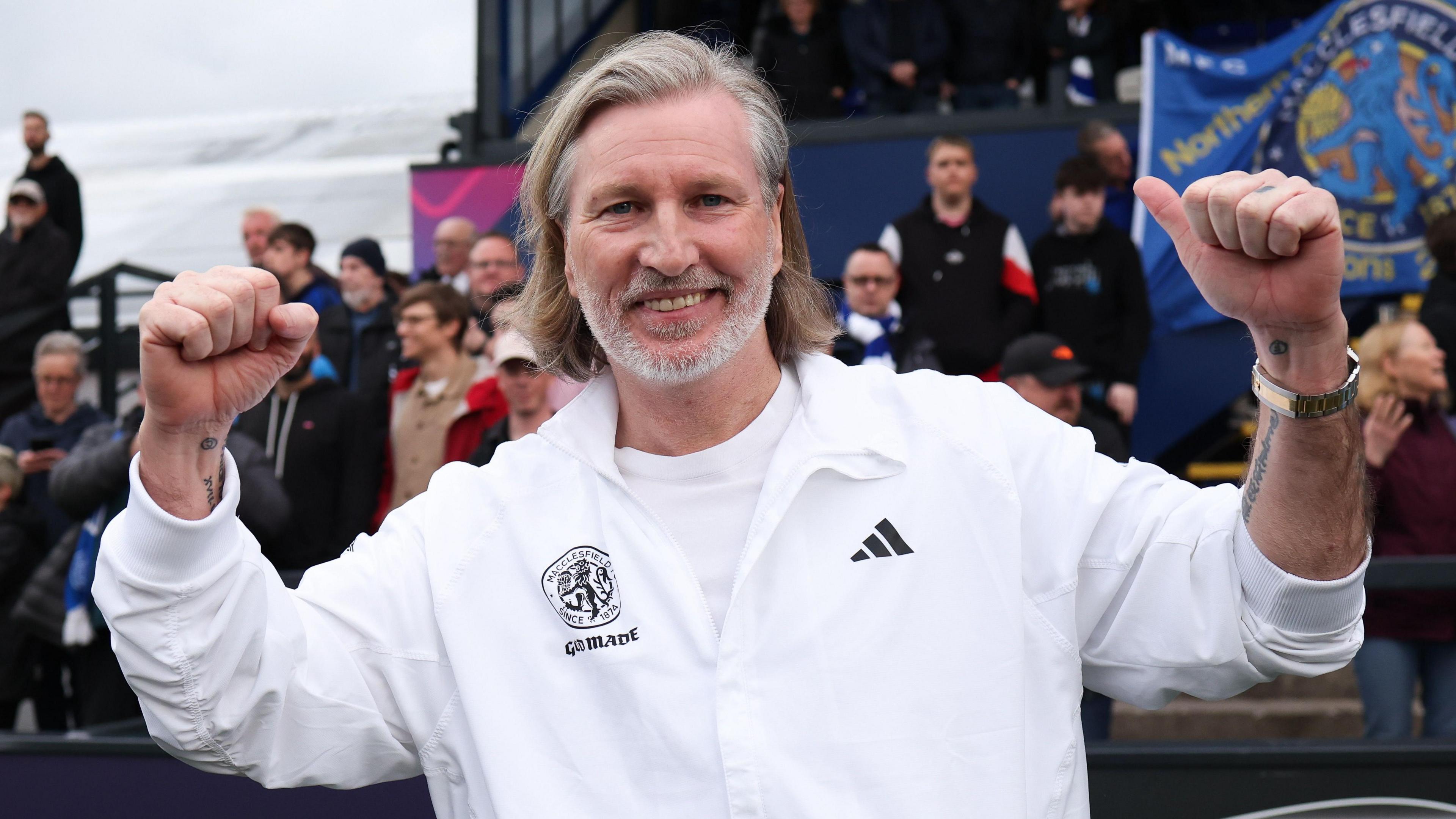 Macclesfield head coach Robbie Savage celebrates winning the Northern Premier League title