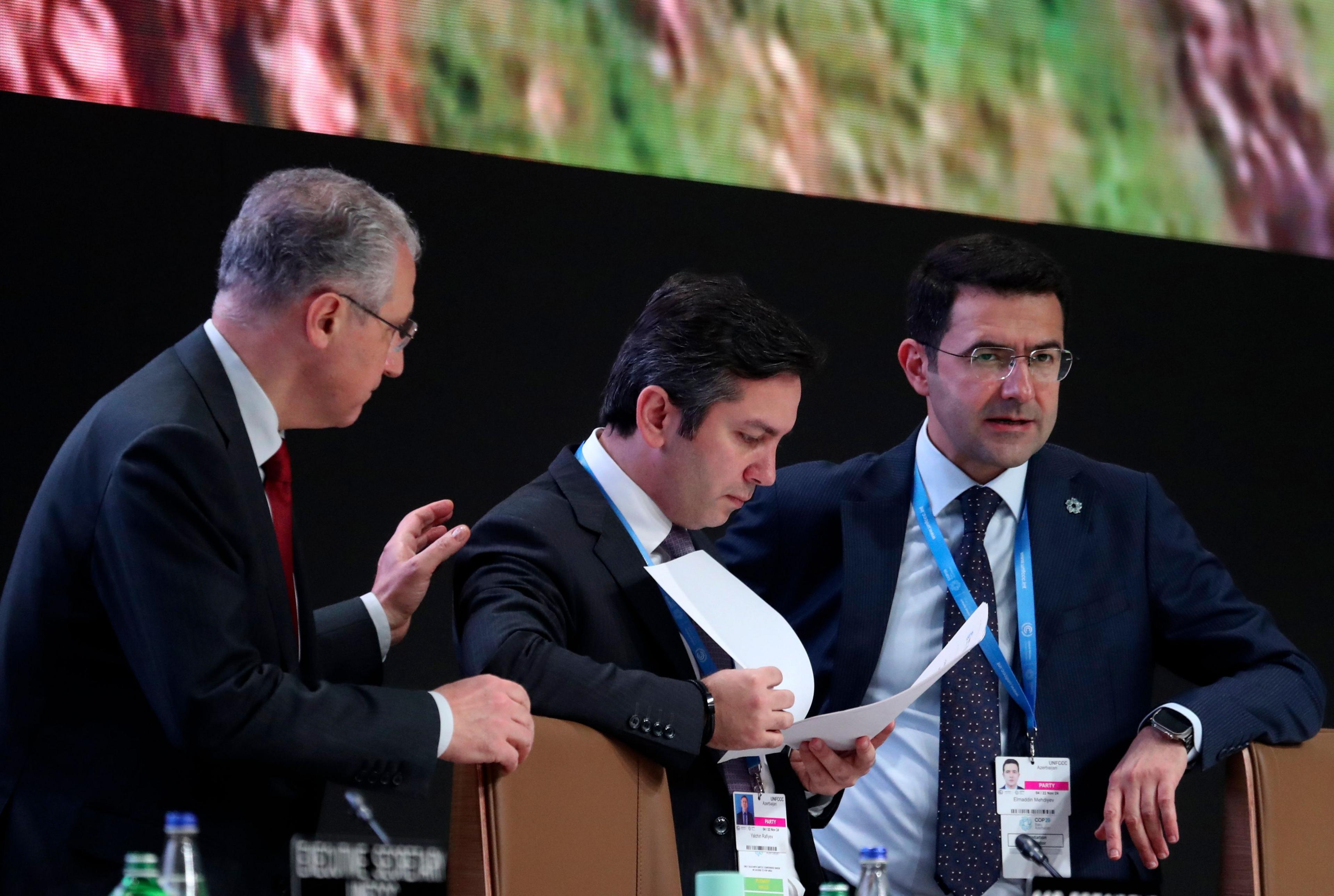 COP29 President Mukhtar Babayev (L) speaks with COP29 Lead Negotiator Yalchin Rafiyev (C) during a plenary session at the United Nations Climate Change Conference COP29 in Baku