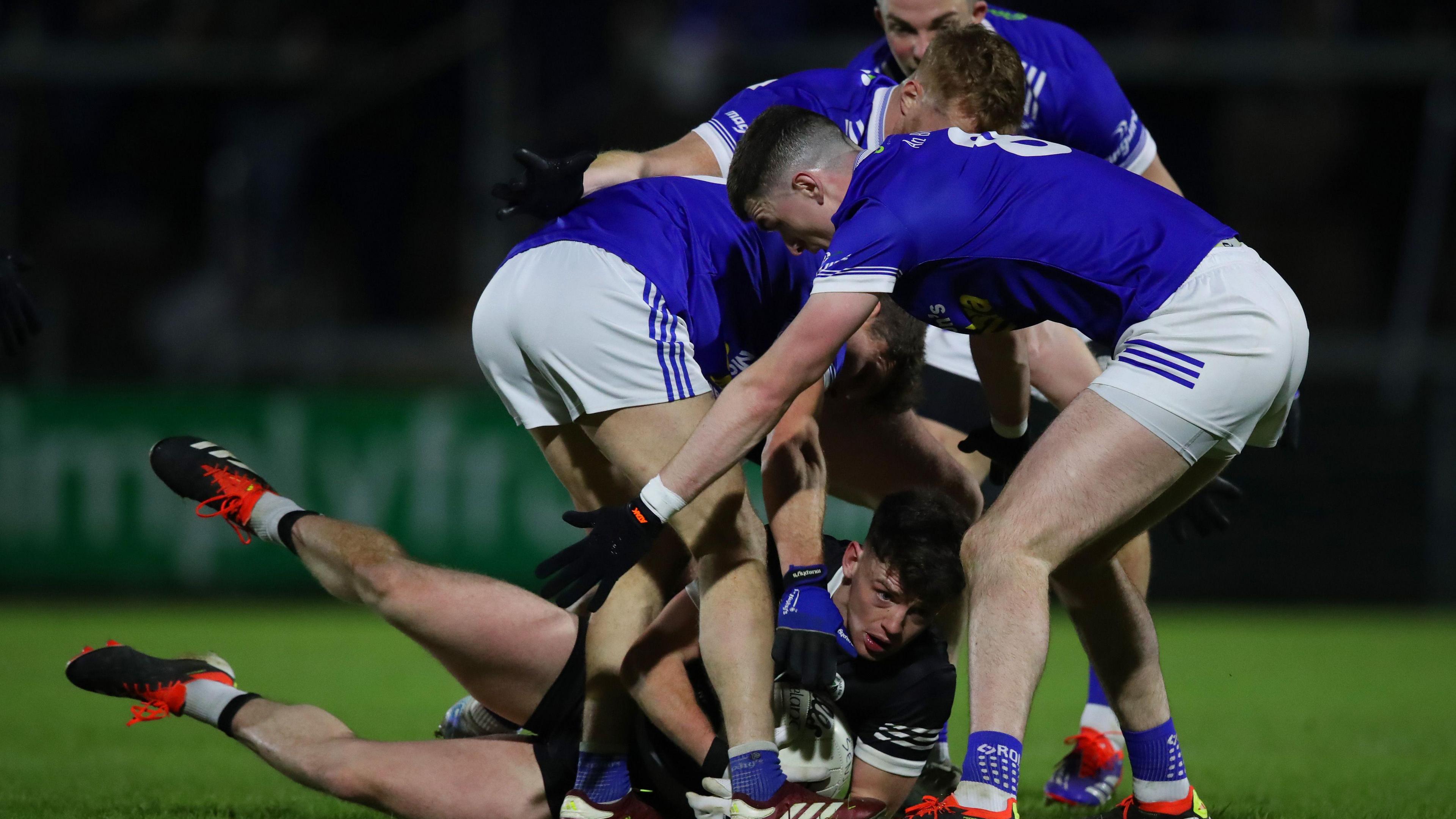 A quartet of Scotstown players close in on Kilcoo's Anthony Morgan