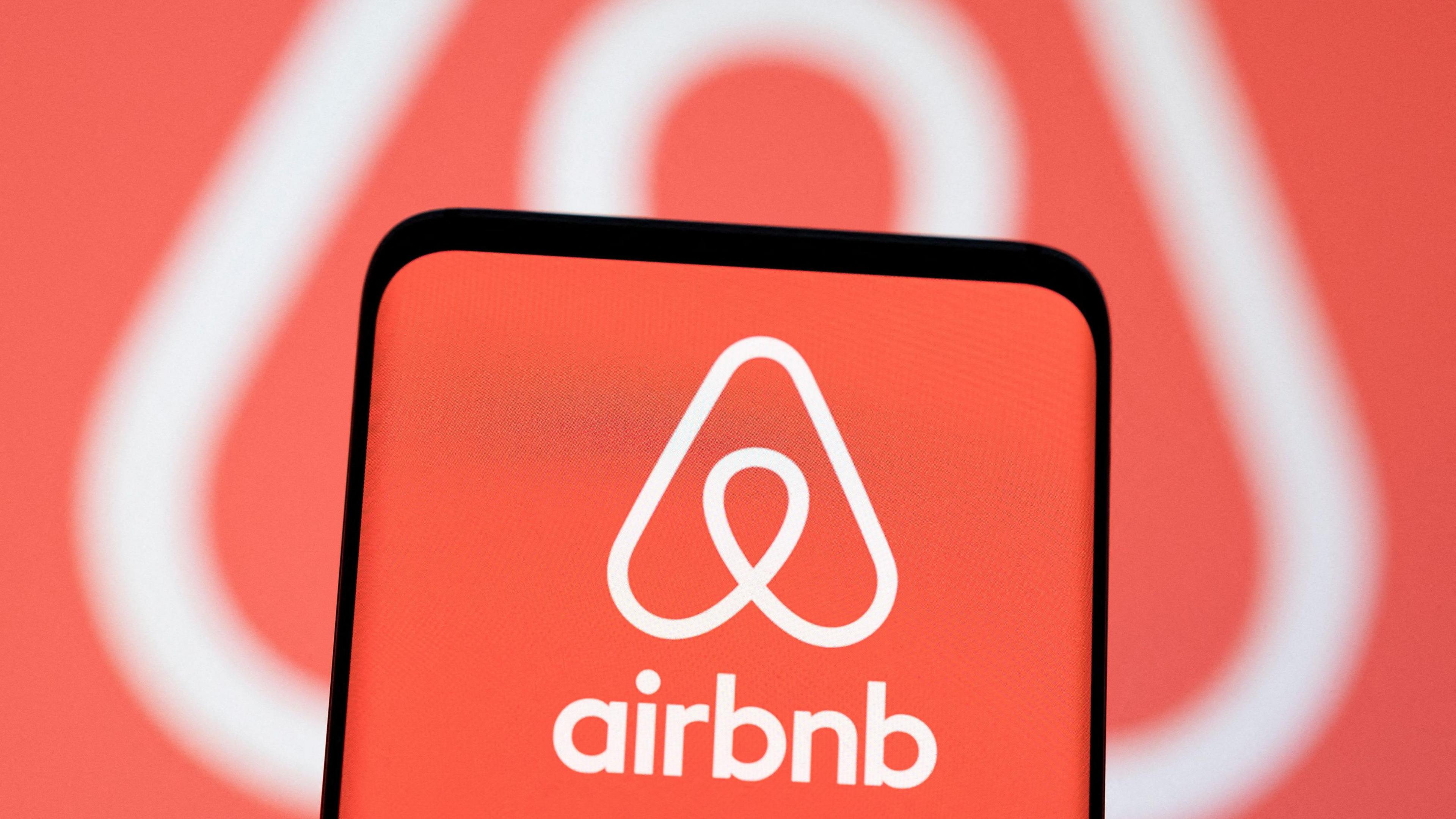 The pink Airbnb logo on an iphone screen