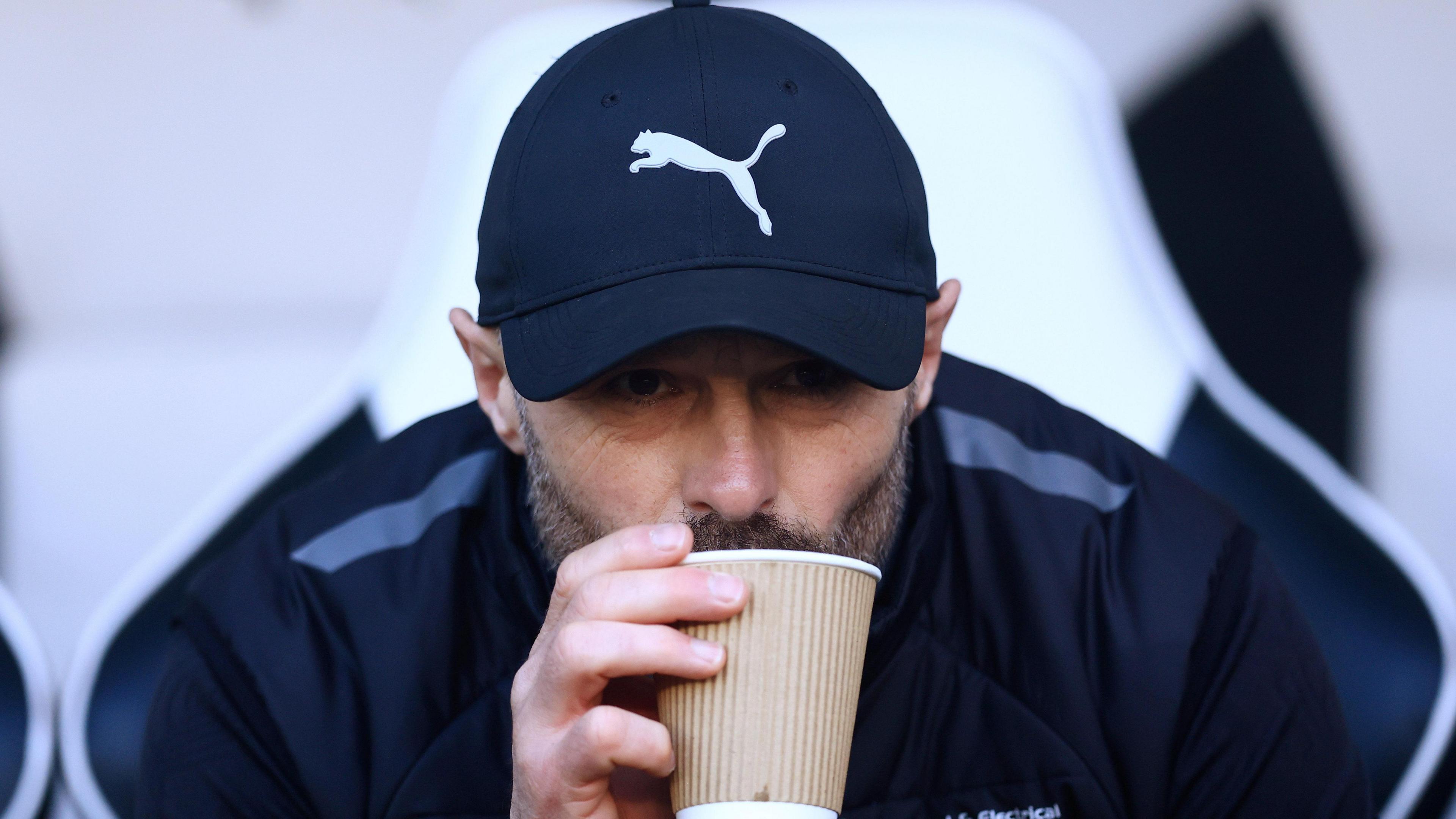 Derby County manager Paul Warne sips from a cup