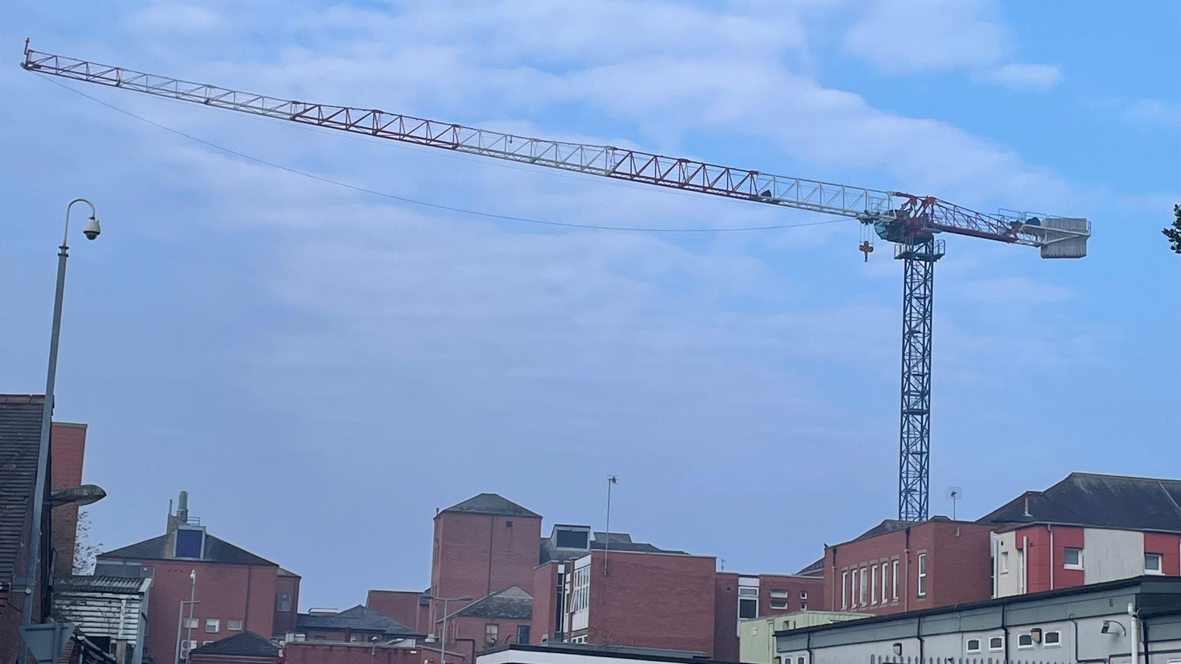 A big blue crane over the hospital