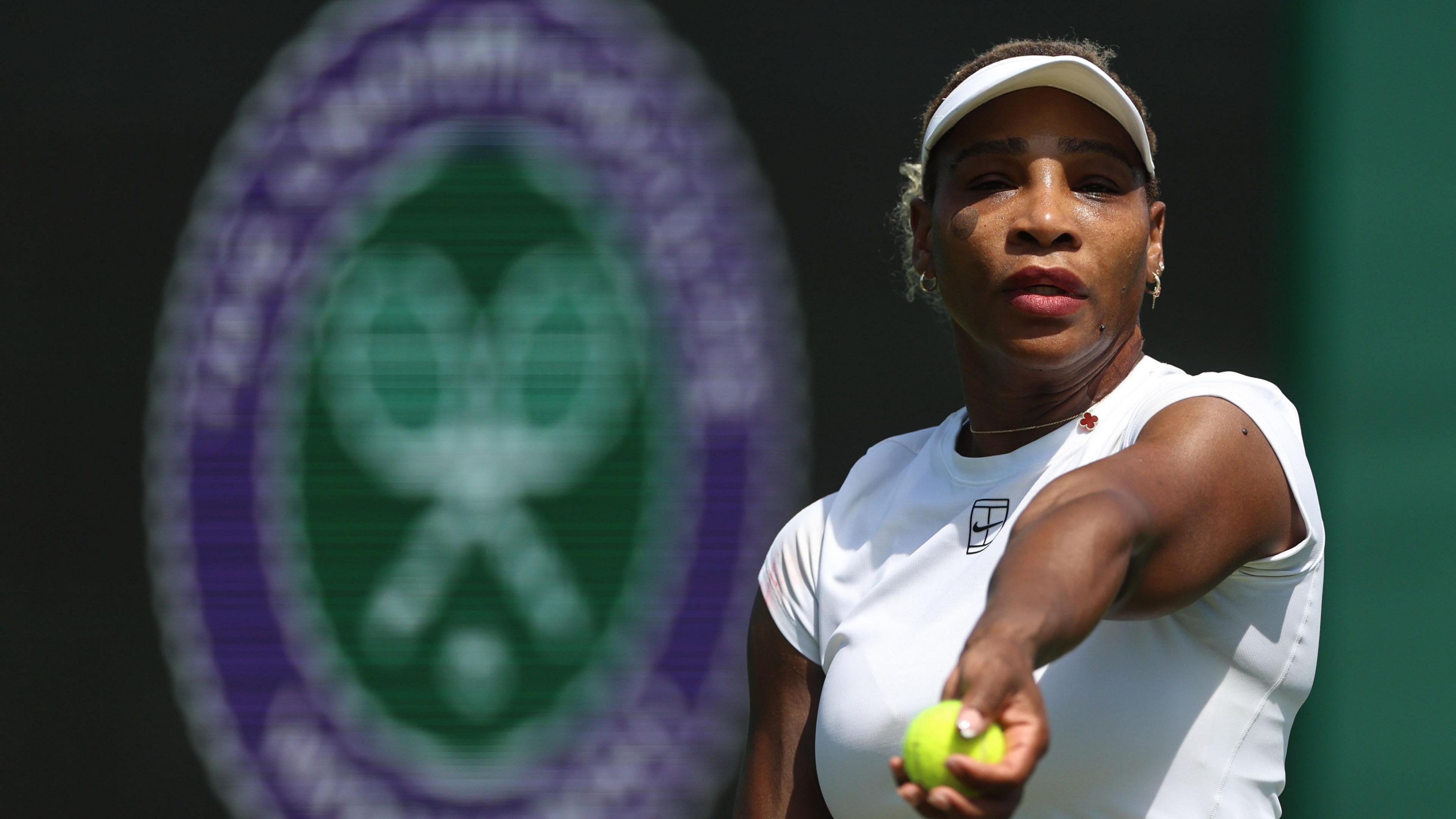 Serena Williams prepares to toss a tennis ball in practice at Wimbledon