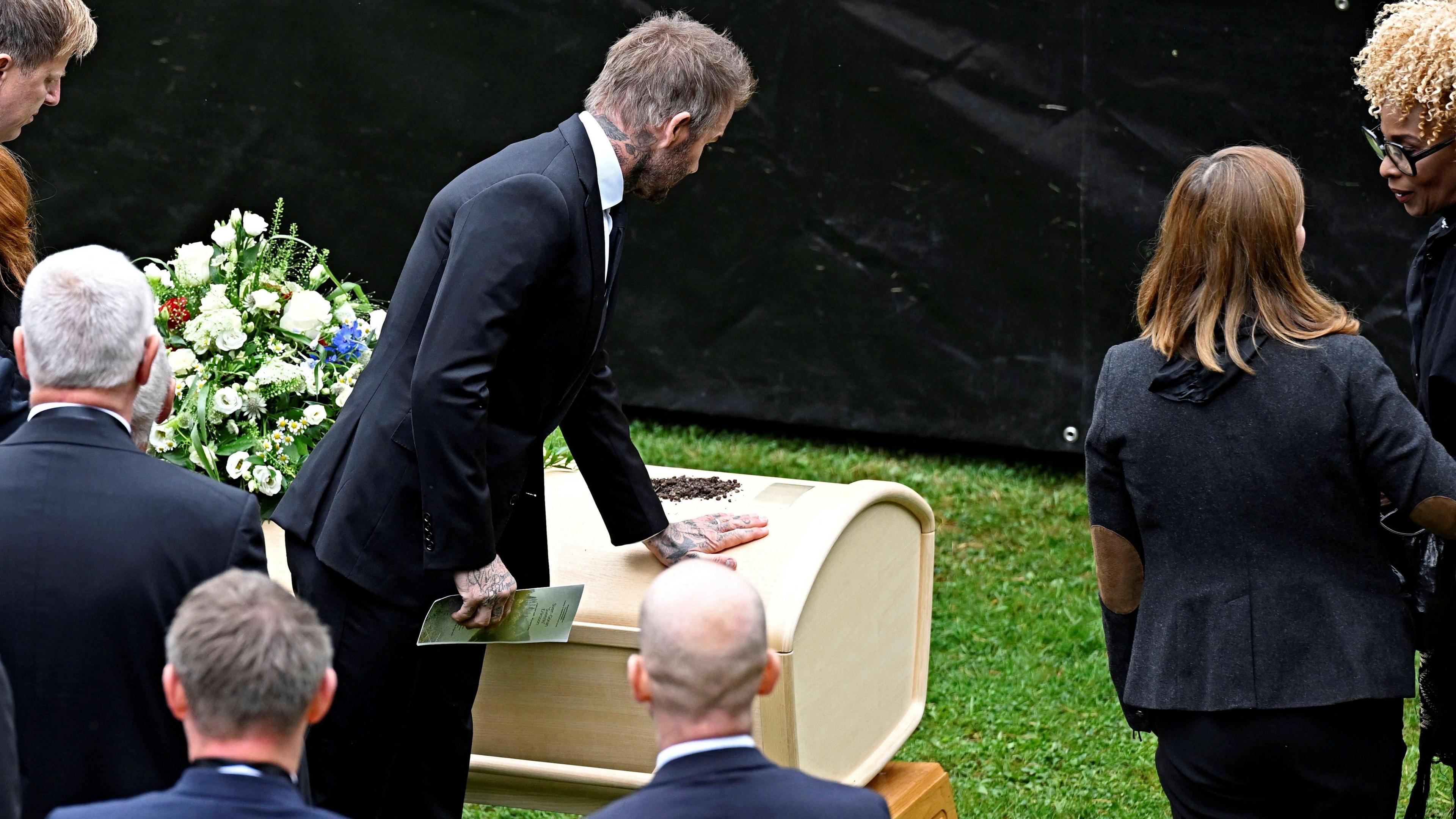 David Beckham places his hand on the coffin of Sven-Goran Eriksson