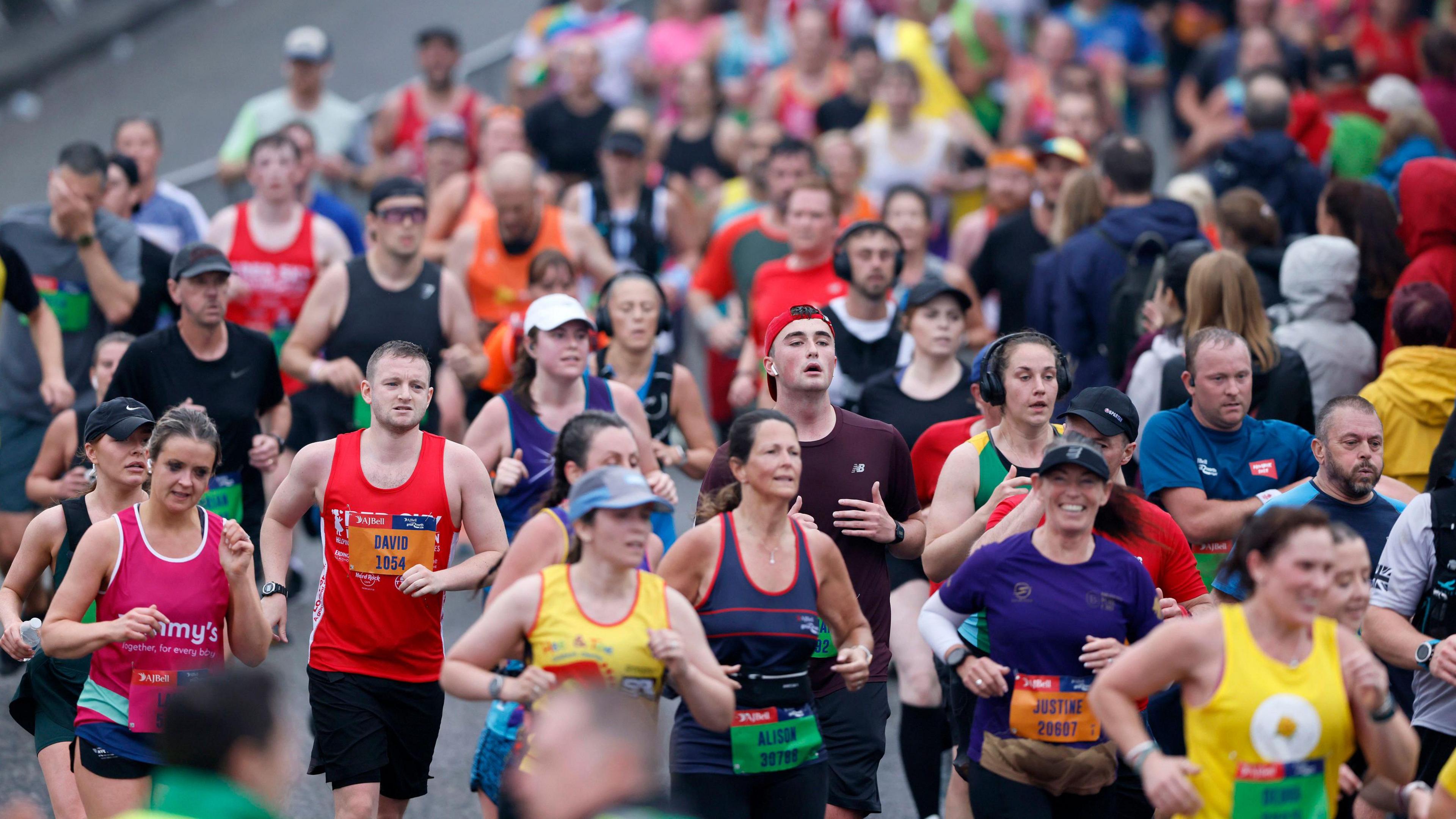 A large crowd of runners taking part in the Great North Run. They are wearing a variety of colourful running clothes.