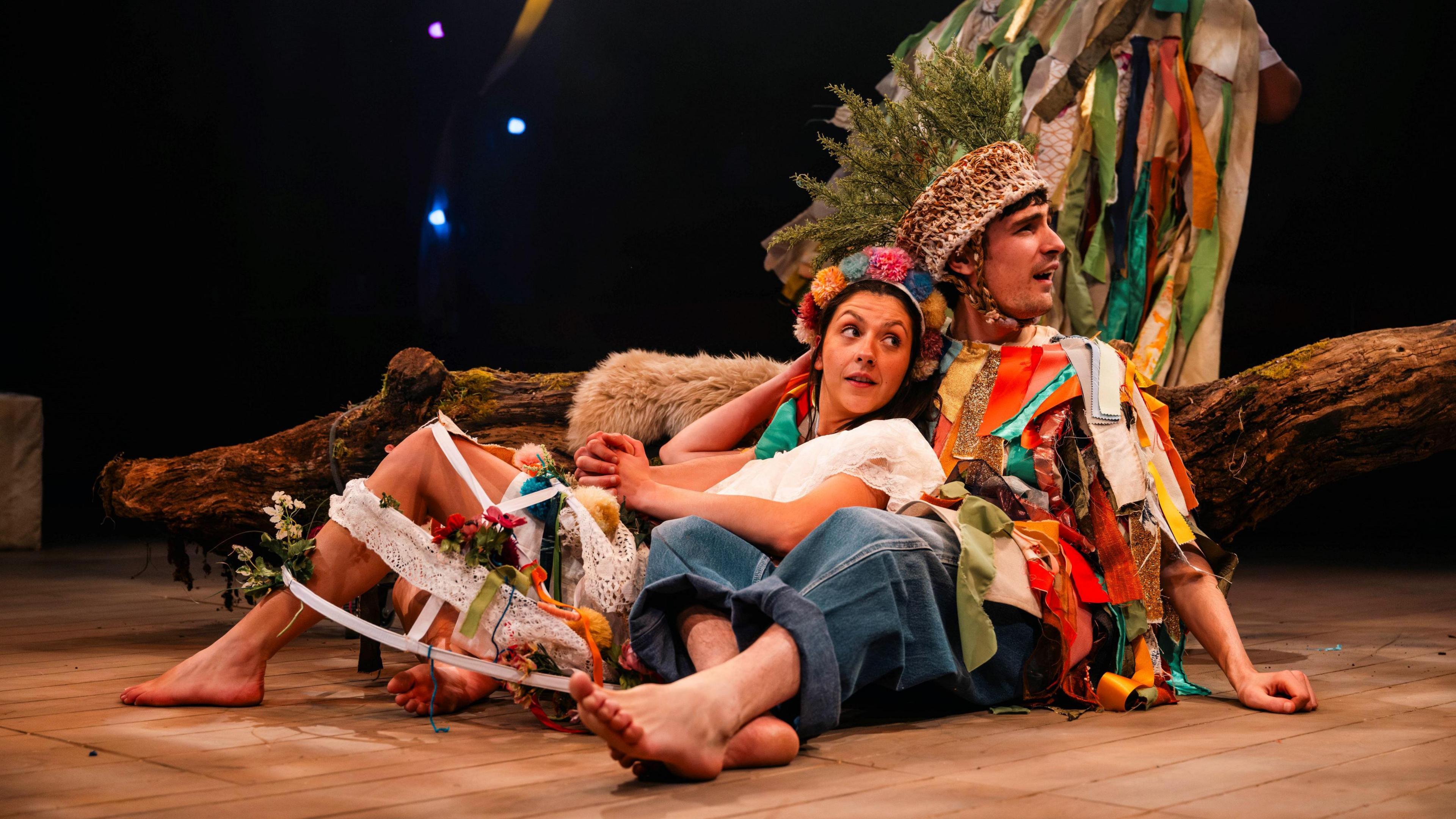 Two actors, one male and one female, lie down in an embrace as part of The Winter's Tale at the Tobacco Factory Theatre in Bristol