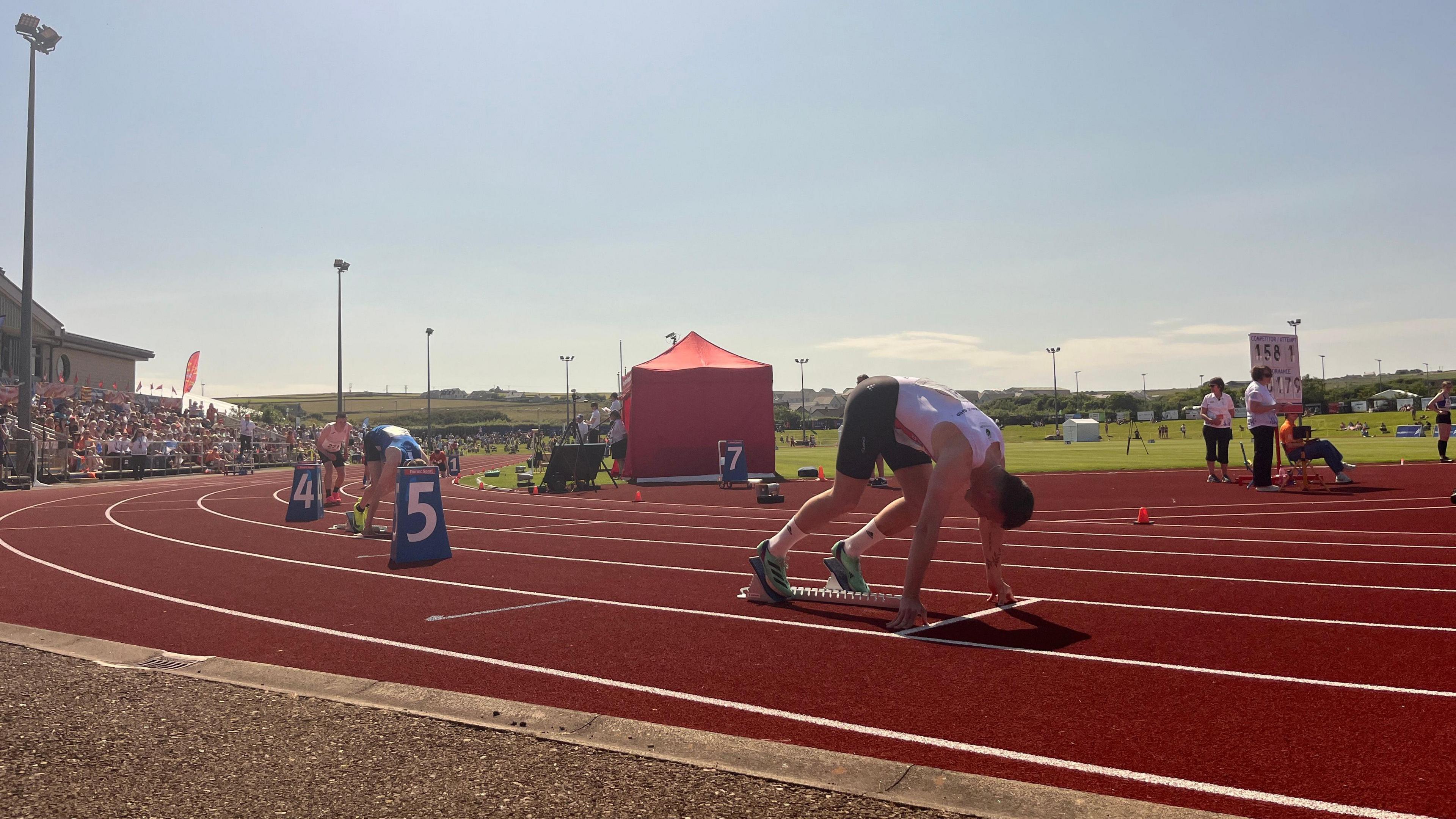Running track, with runner pictured about to start running