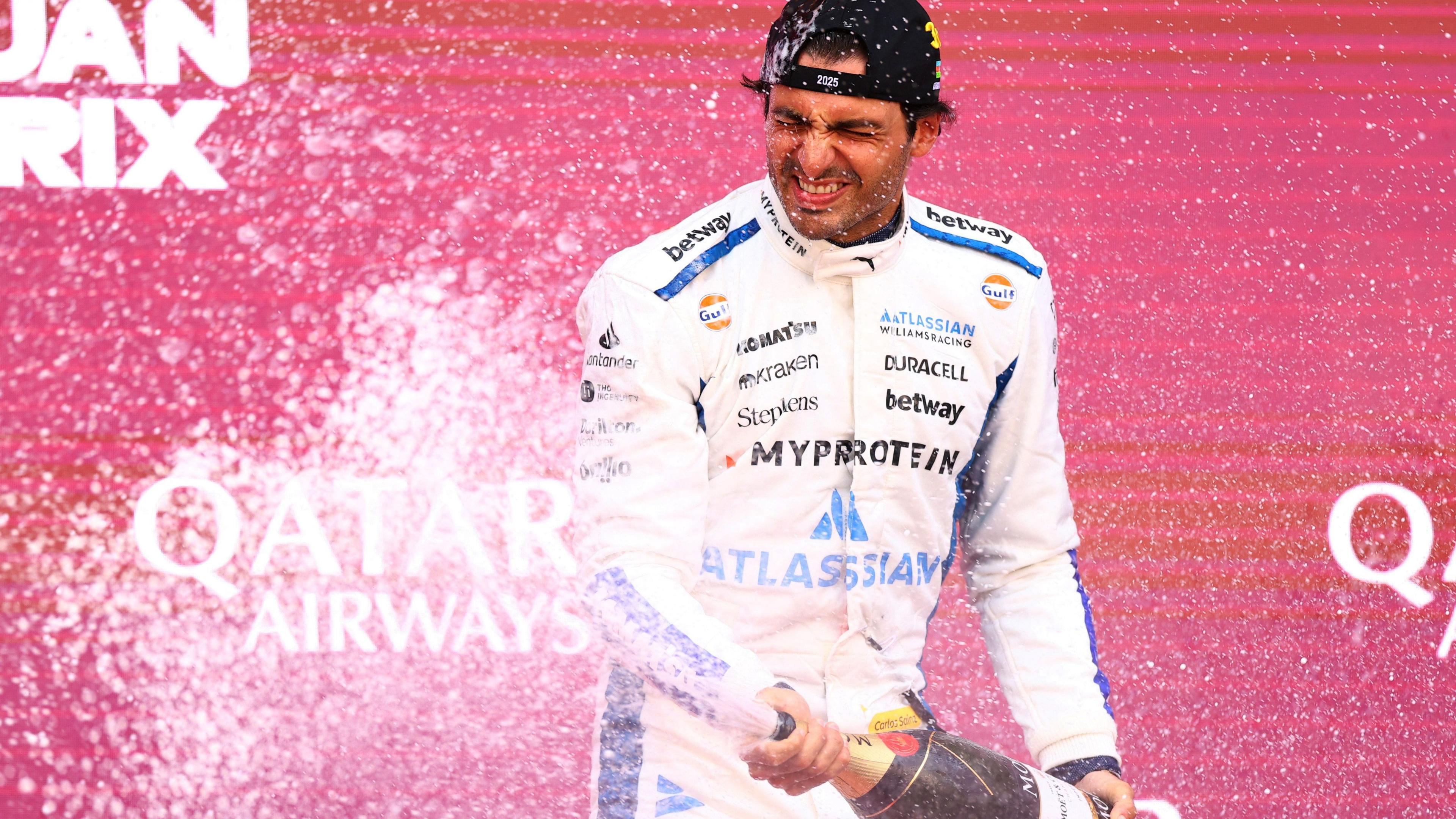 Williams driver Carlos Sainz sprays champagne on the podium after finishing third in the Azerbaijan Grand Prix