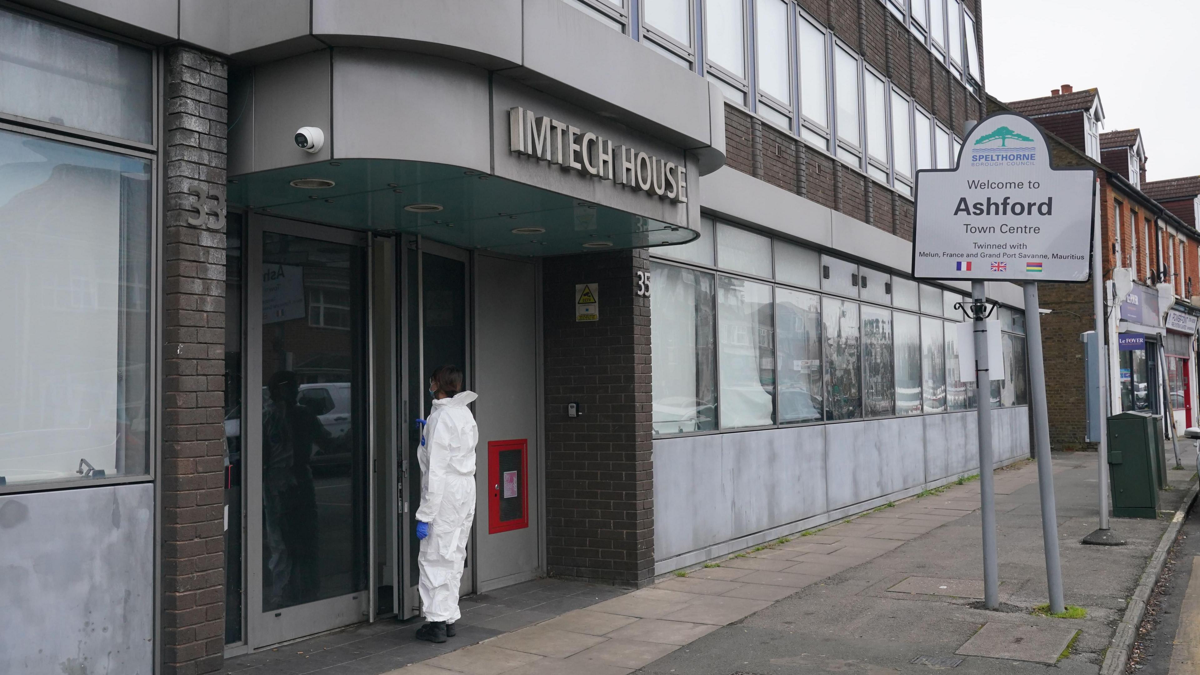 A forensics officer entering Imtech House on Woodthorpe Road in Ashford, Surrey