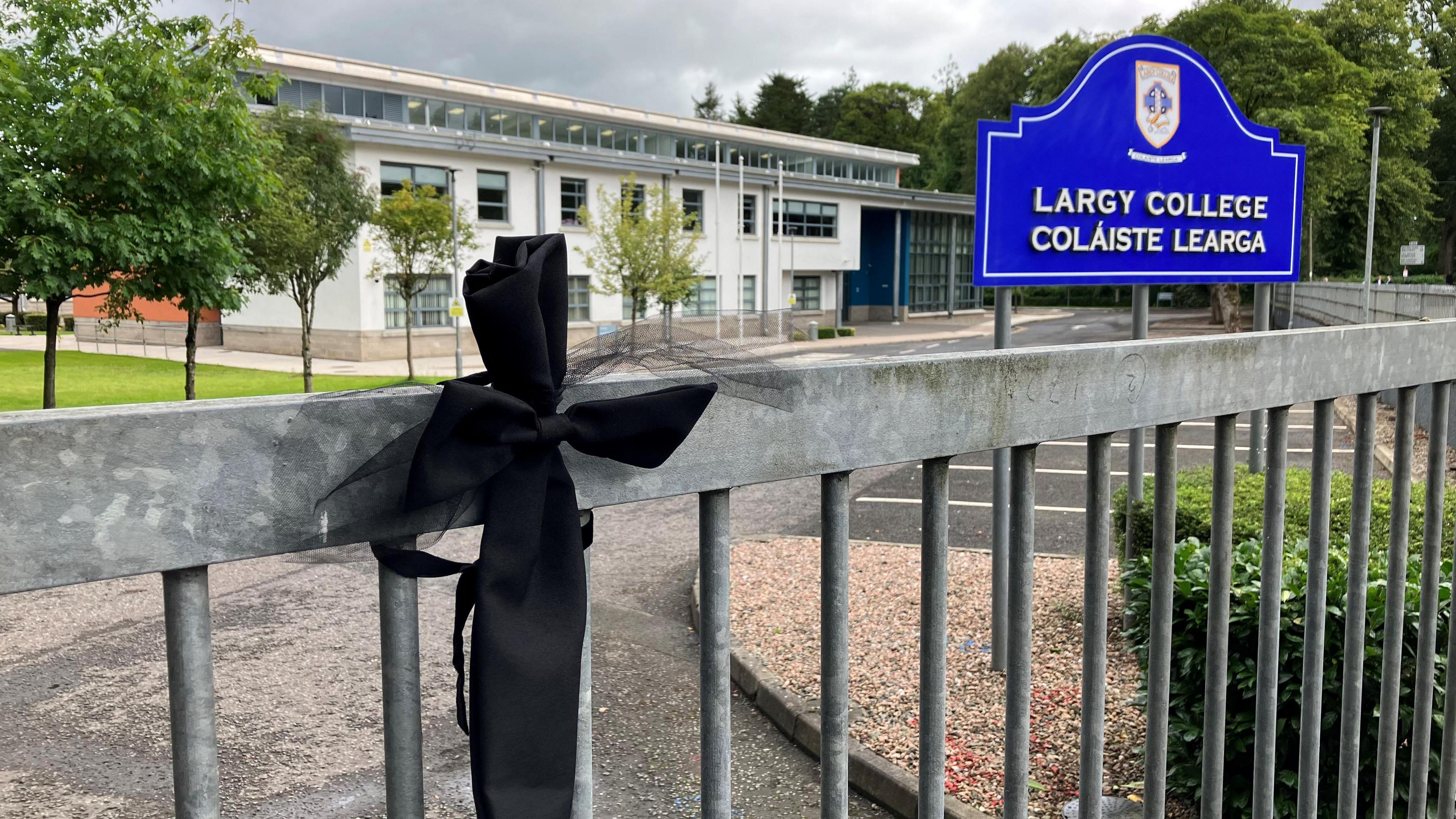 A black bow-tie attached to the gate at Largy College