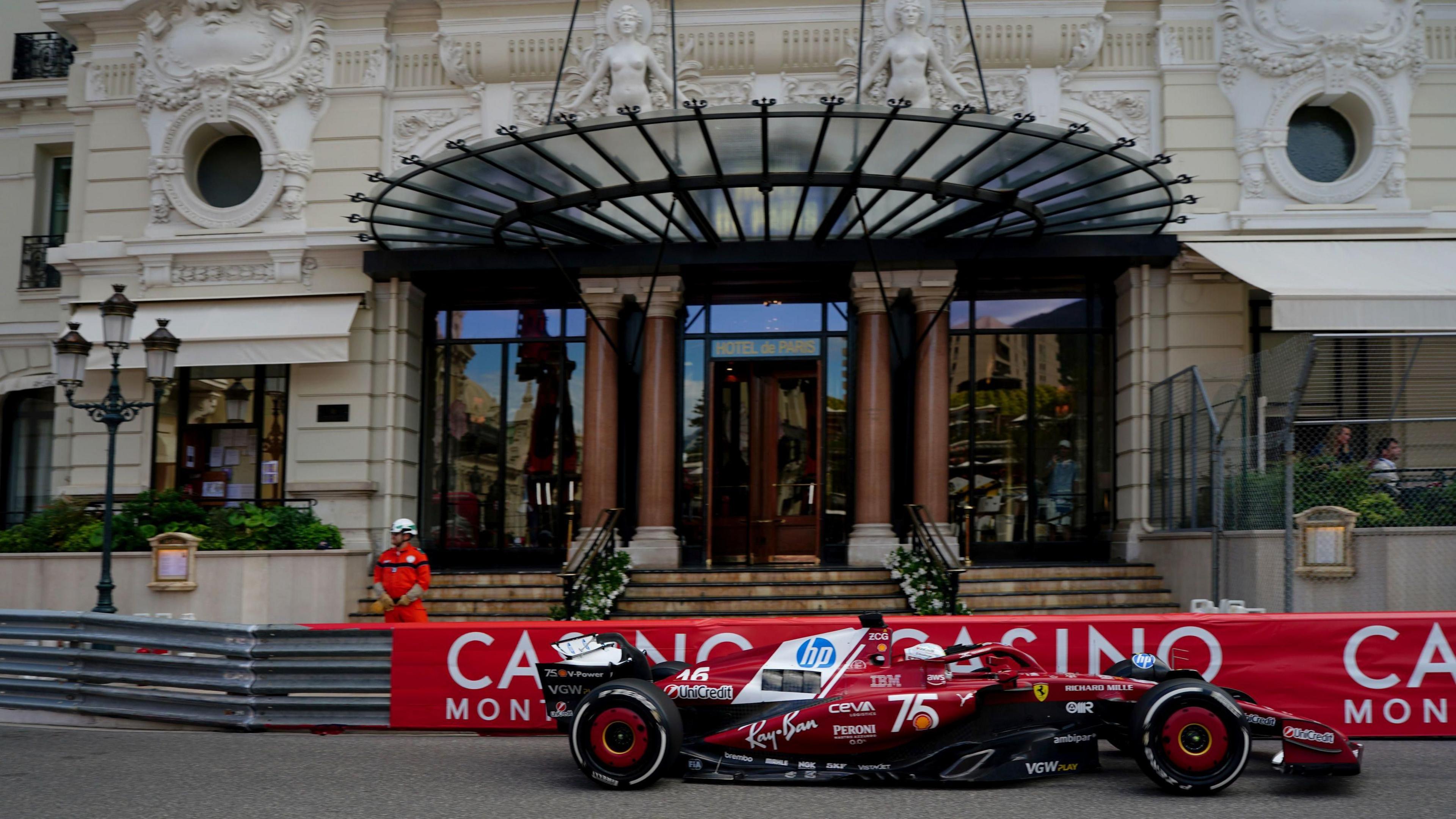 Charles Leclerc drives past the Casino in Monaco 