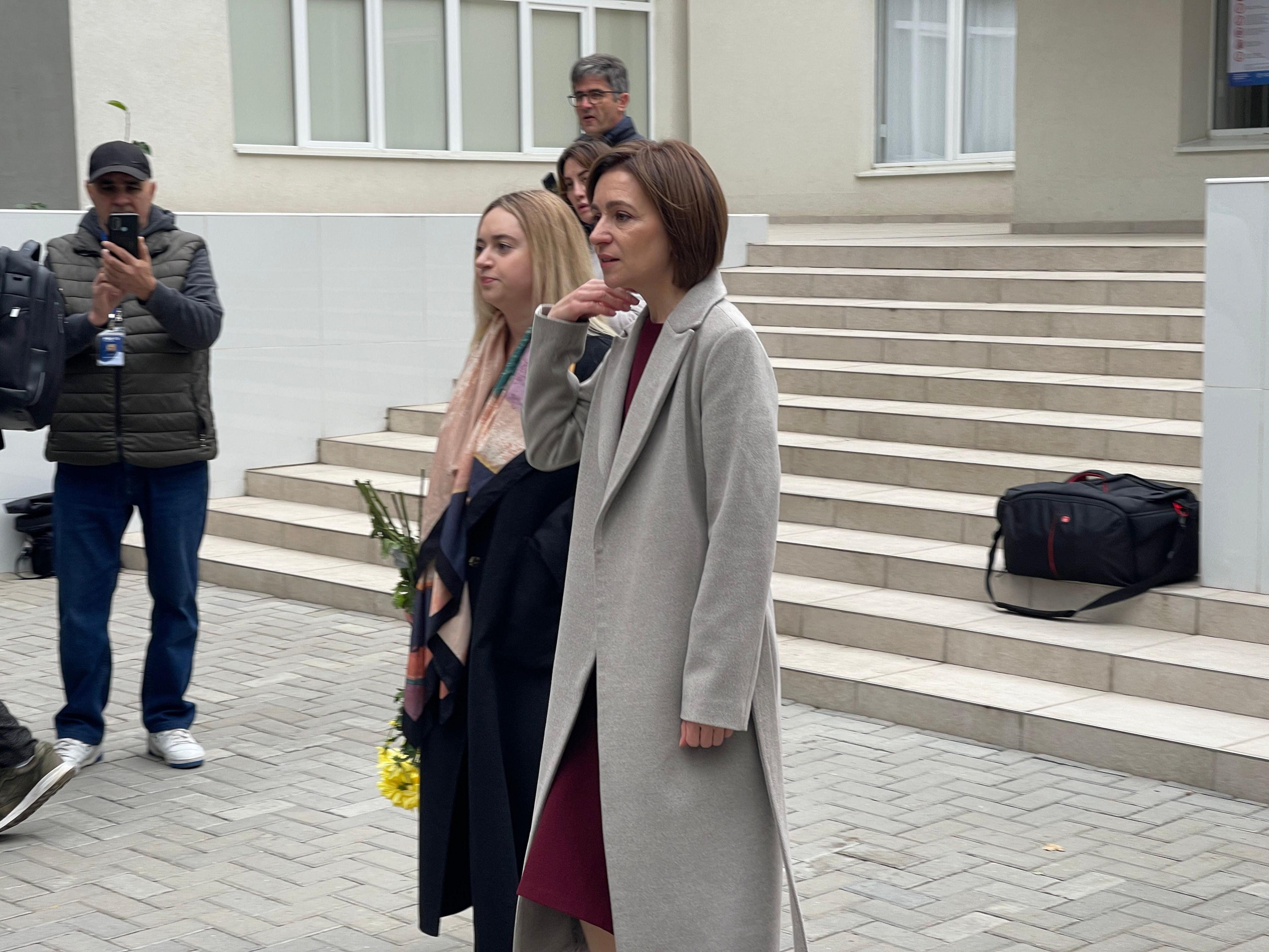 Maia Sandu walking in the street wearing a grey coat