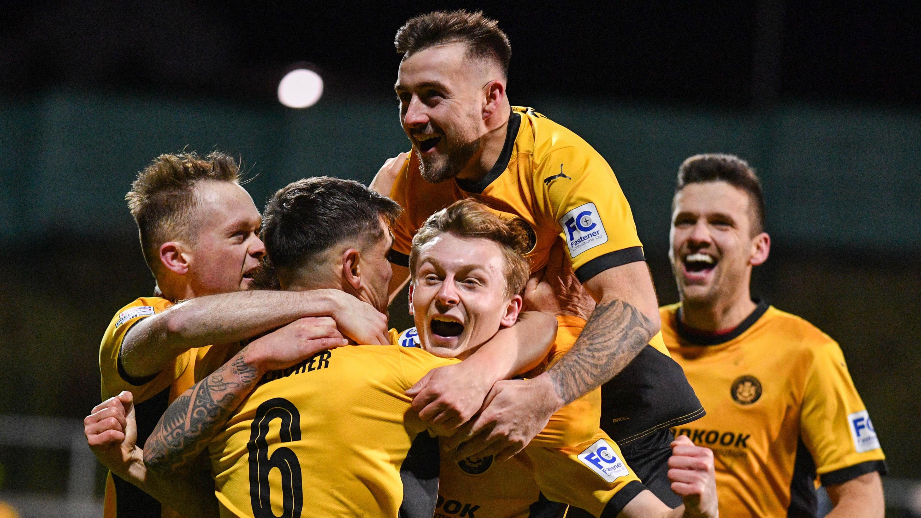 Players celebrate with Jimmy Callacher