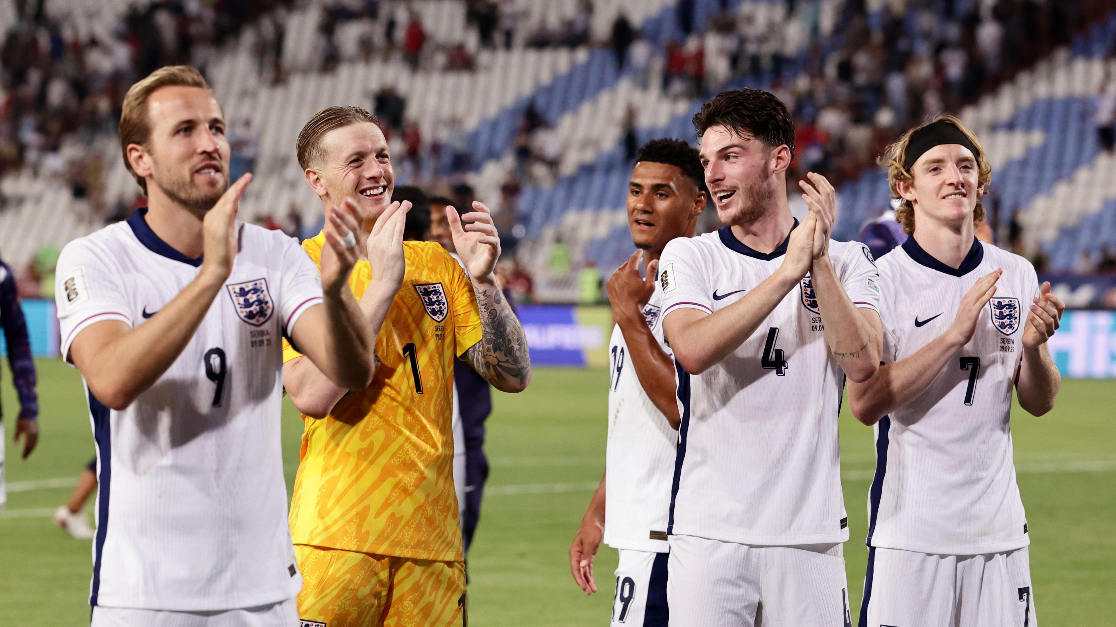 England players - Harry Kane, Declan Rice, Jordan Pickford, Ollie Watkins and Anthony Gordon - clap fans after beating Serbia in World Cup qualifying match in Belgrade