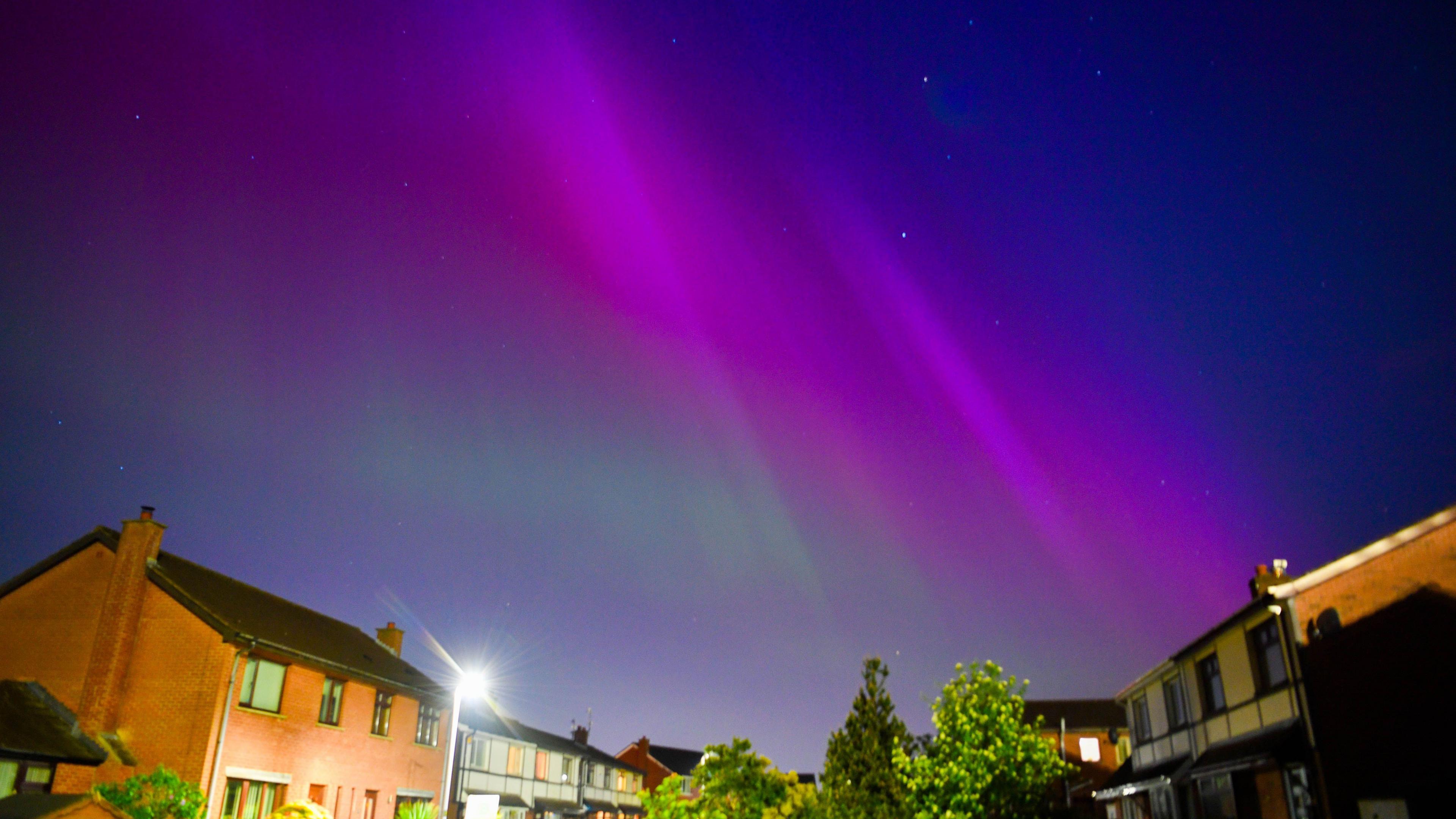 Northern lights over houses