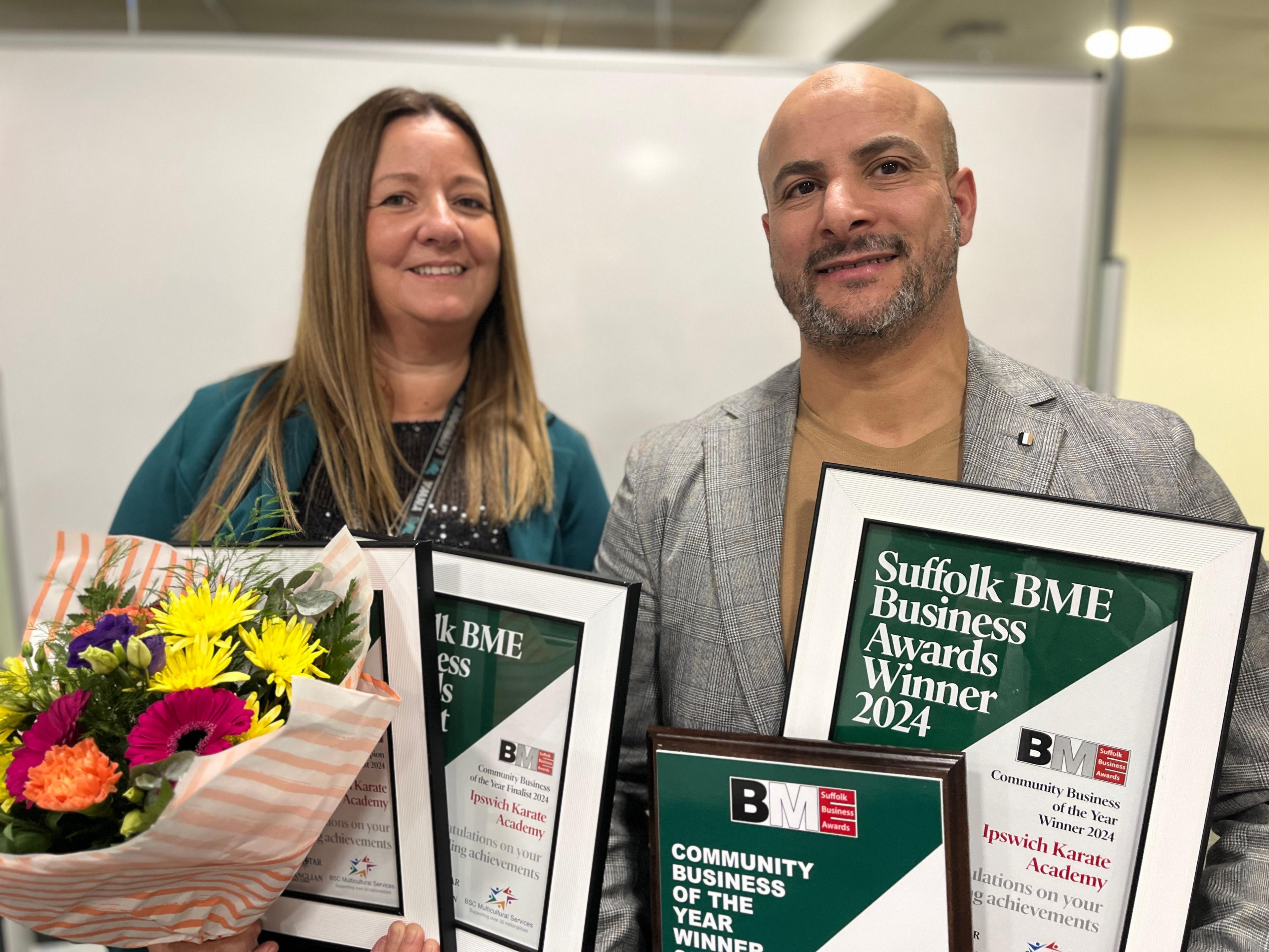 Kelly Peck and Hazem Attia holding award certificates.