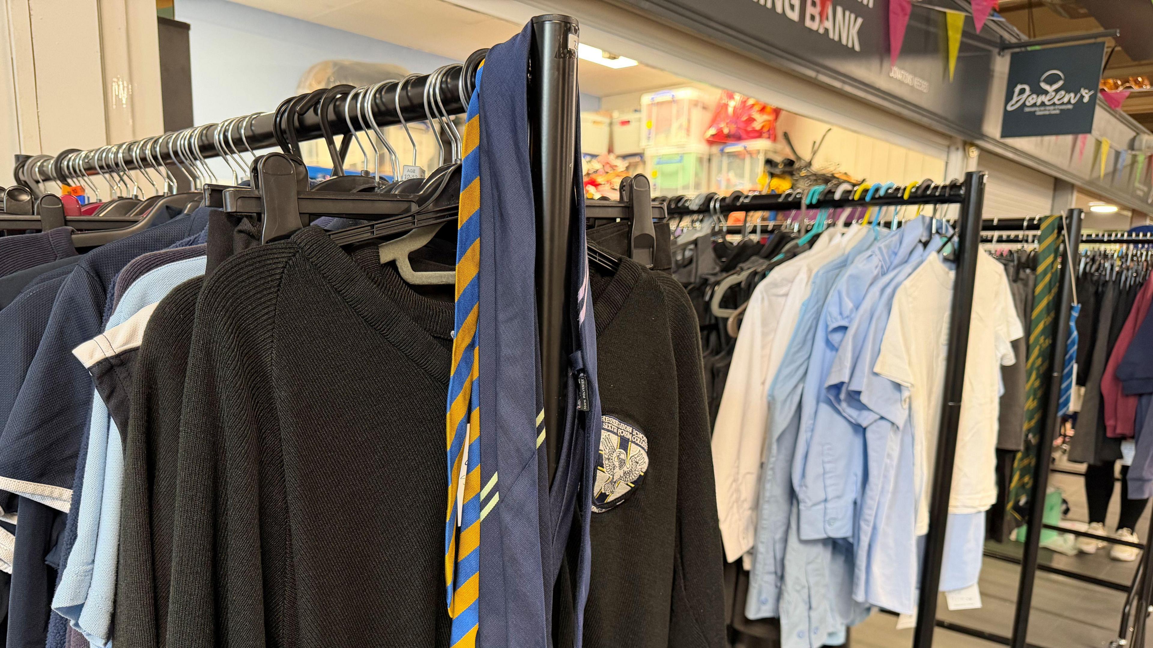 Multiple rails of school uniform.