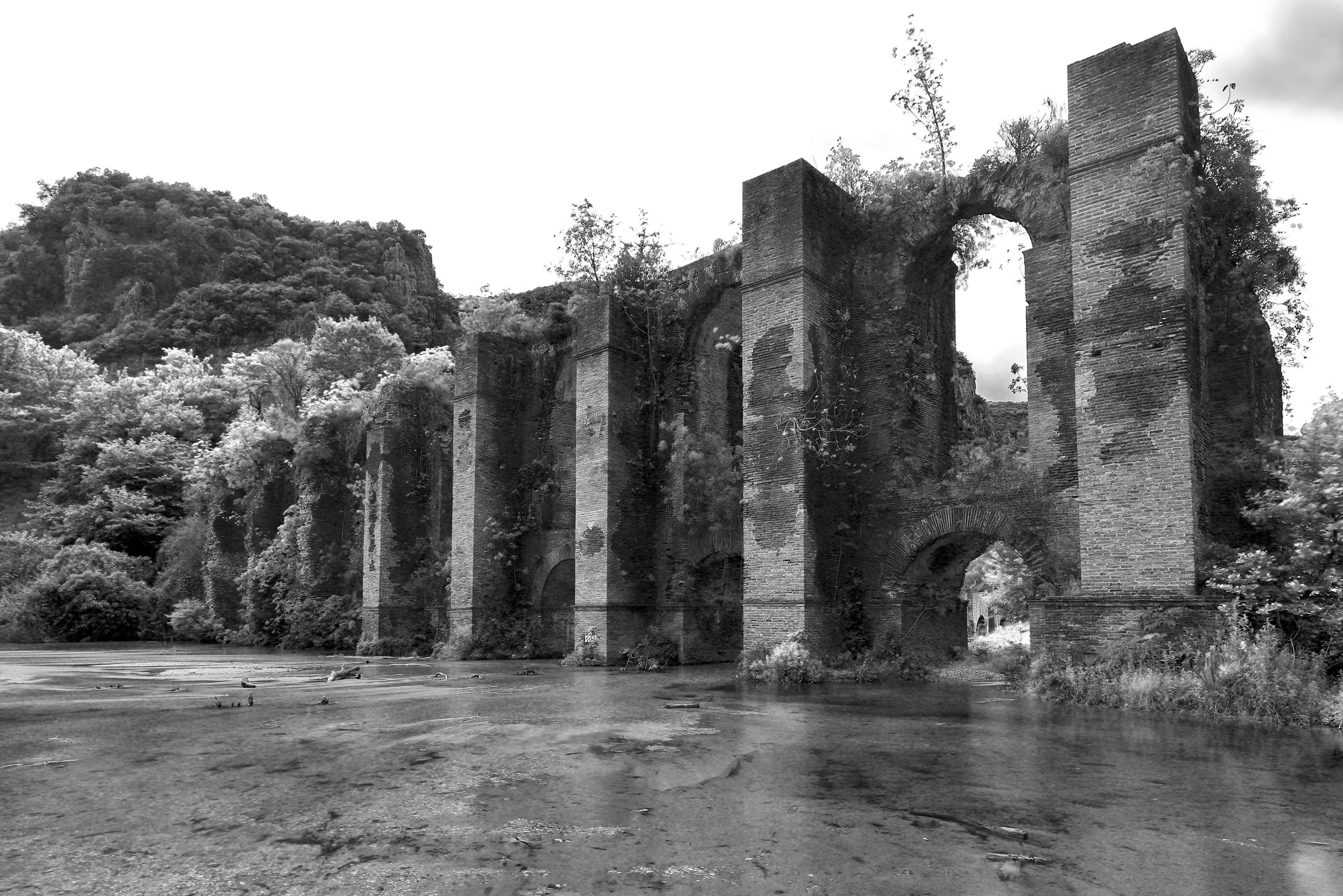 Roman aqueduct ruins, covered in vegetation, Nikopolis, Greece
