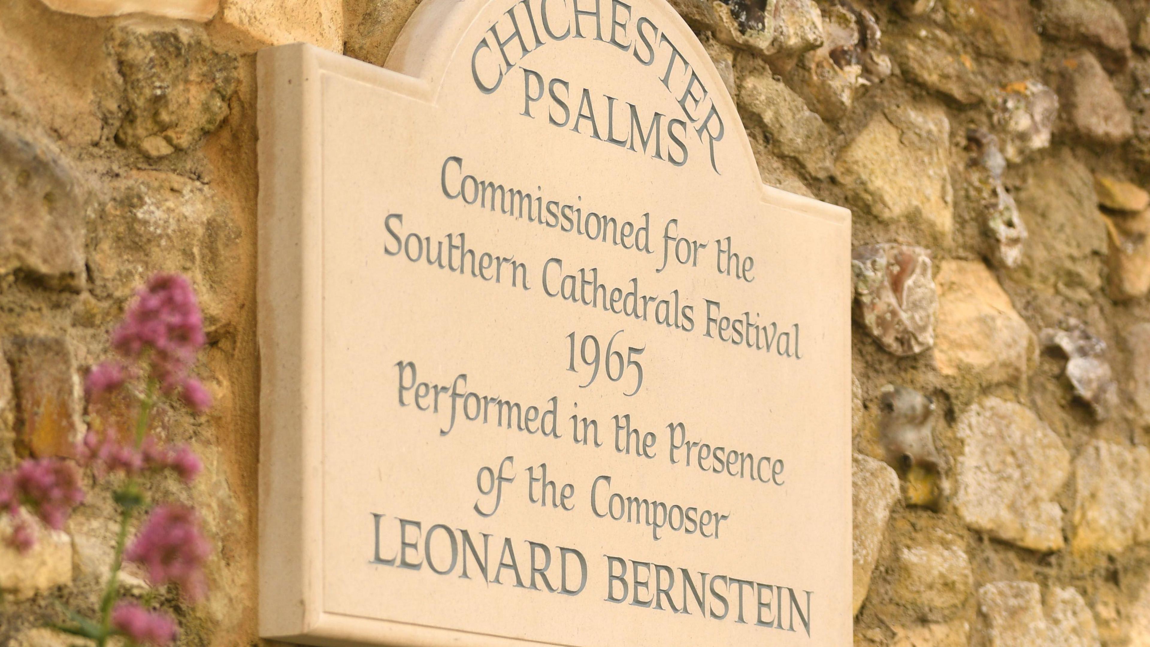 A plaque to Leonard Berntein on the side of a brick wall