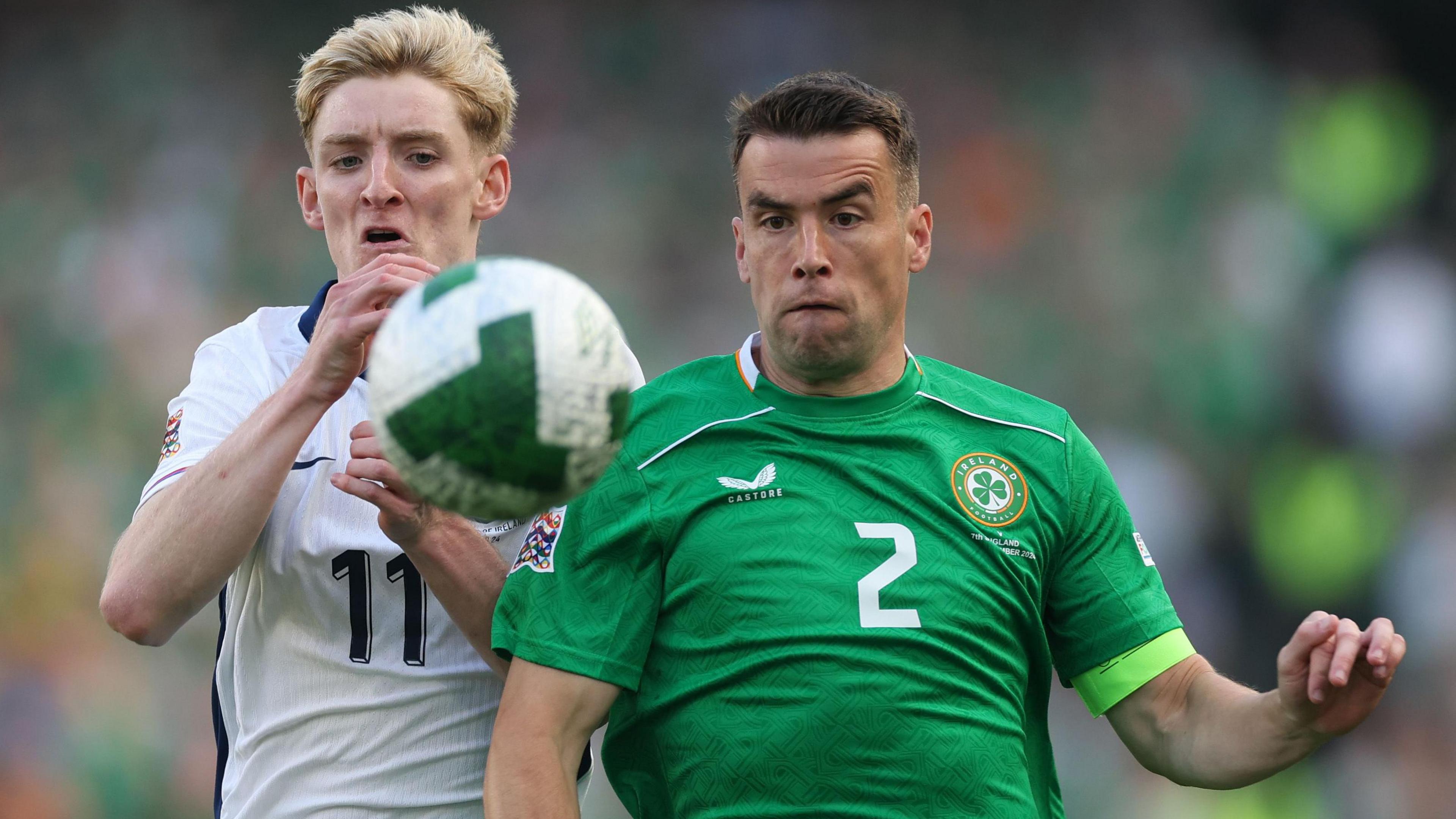 Seamus Coleman battles for the ball with Anthony Gordon