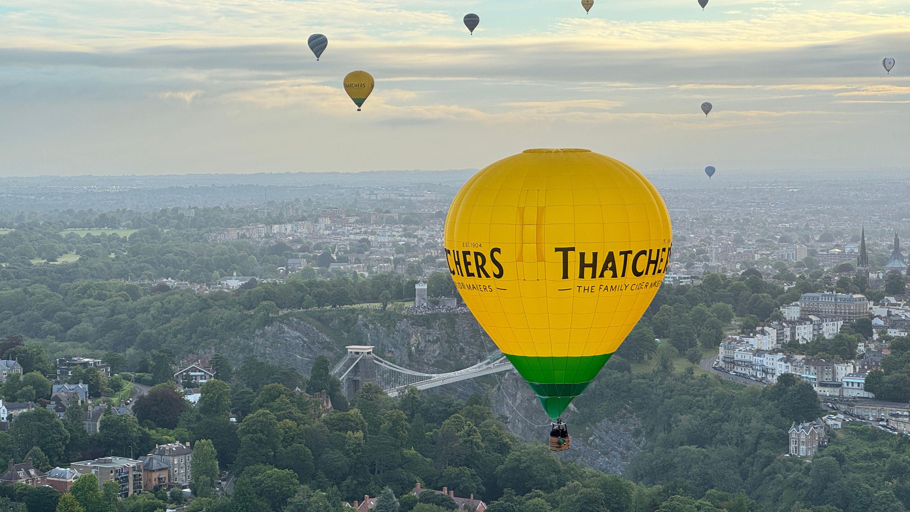 Yellow Thatchers hot air balloon over Bristol