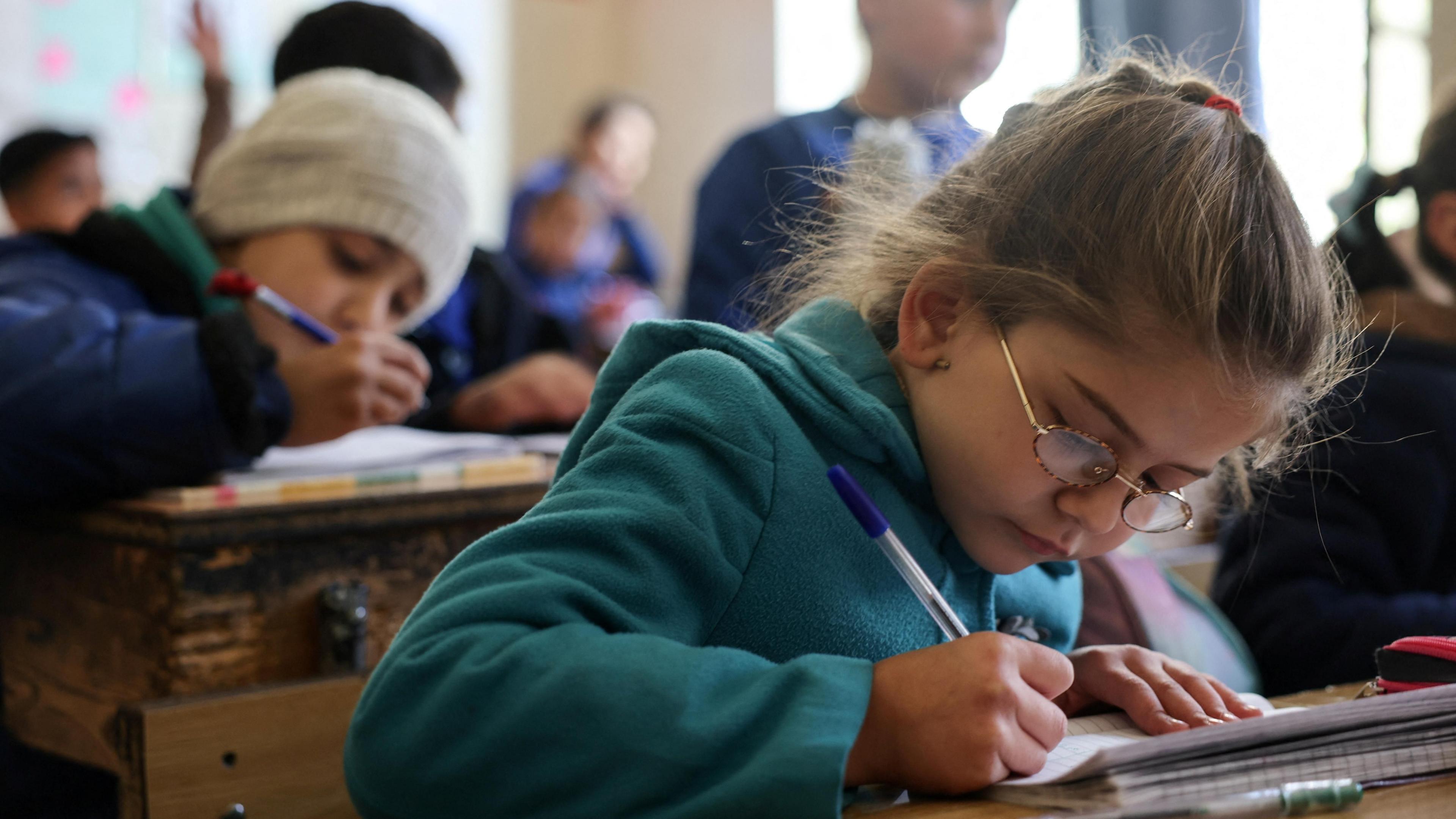 Syrian children study at a school in Damascus, Syria (19 December 2024)