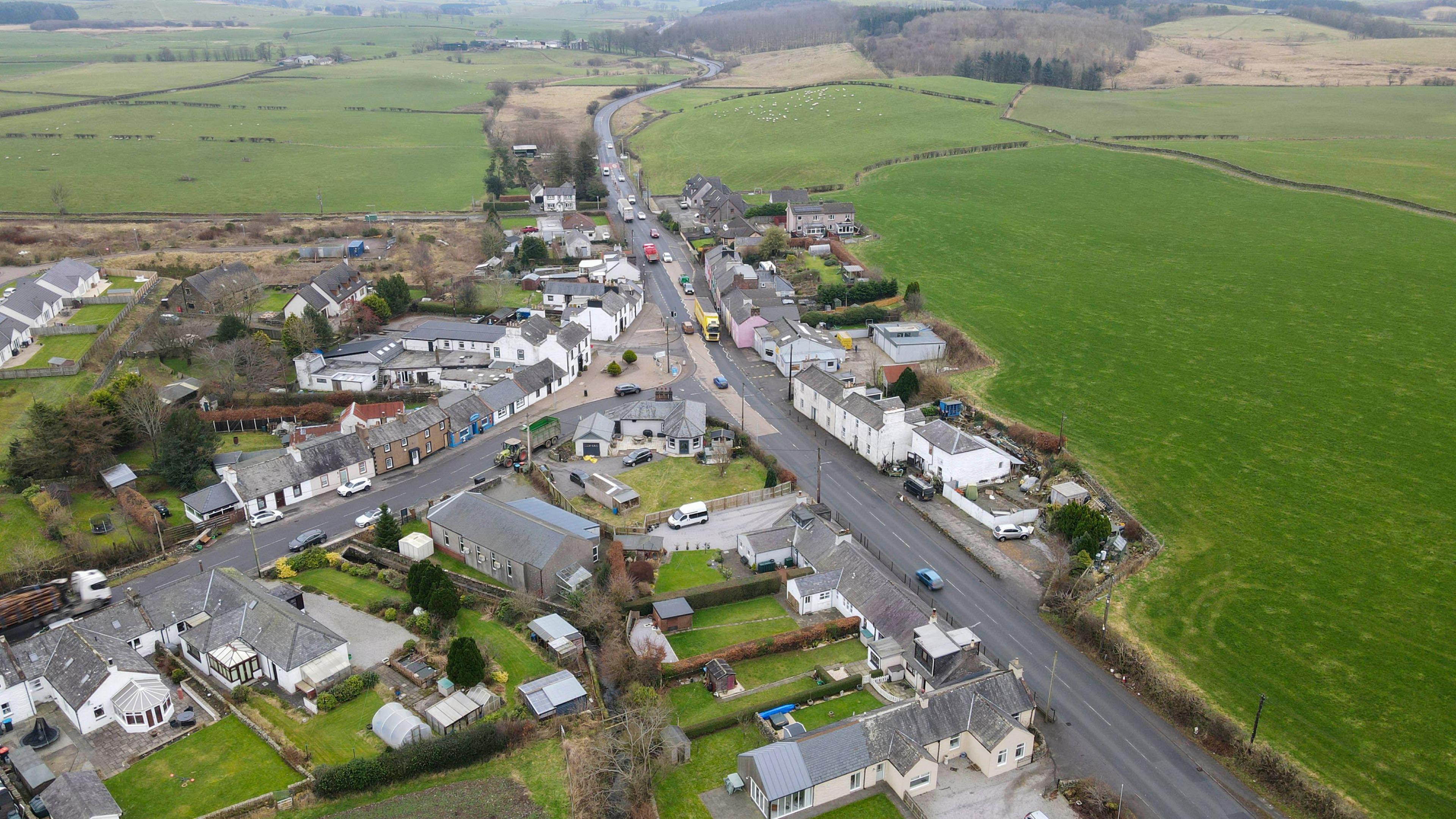 An aerial view of the A75 wending its way through the village of Crocketford