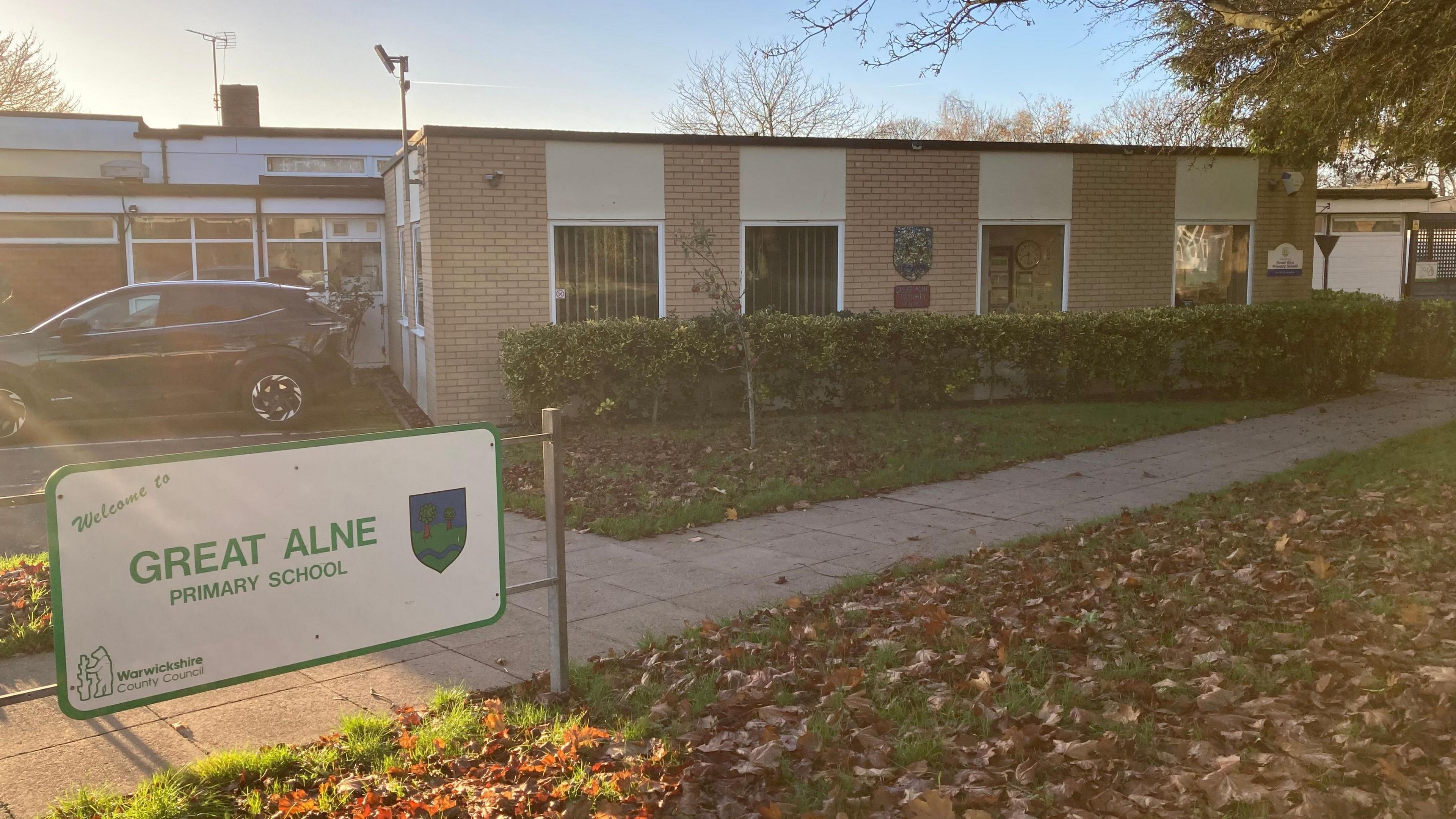 There is a sign saying welcome to Great Alne Primary school in front of the school building.