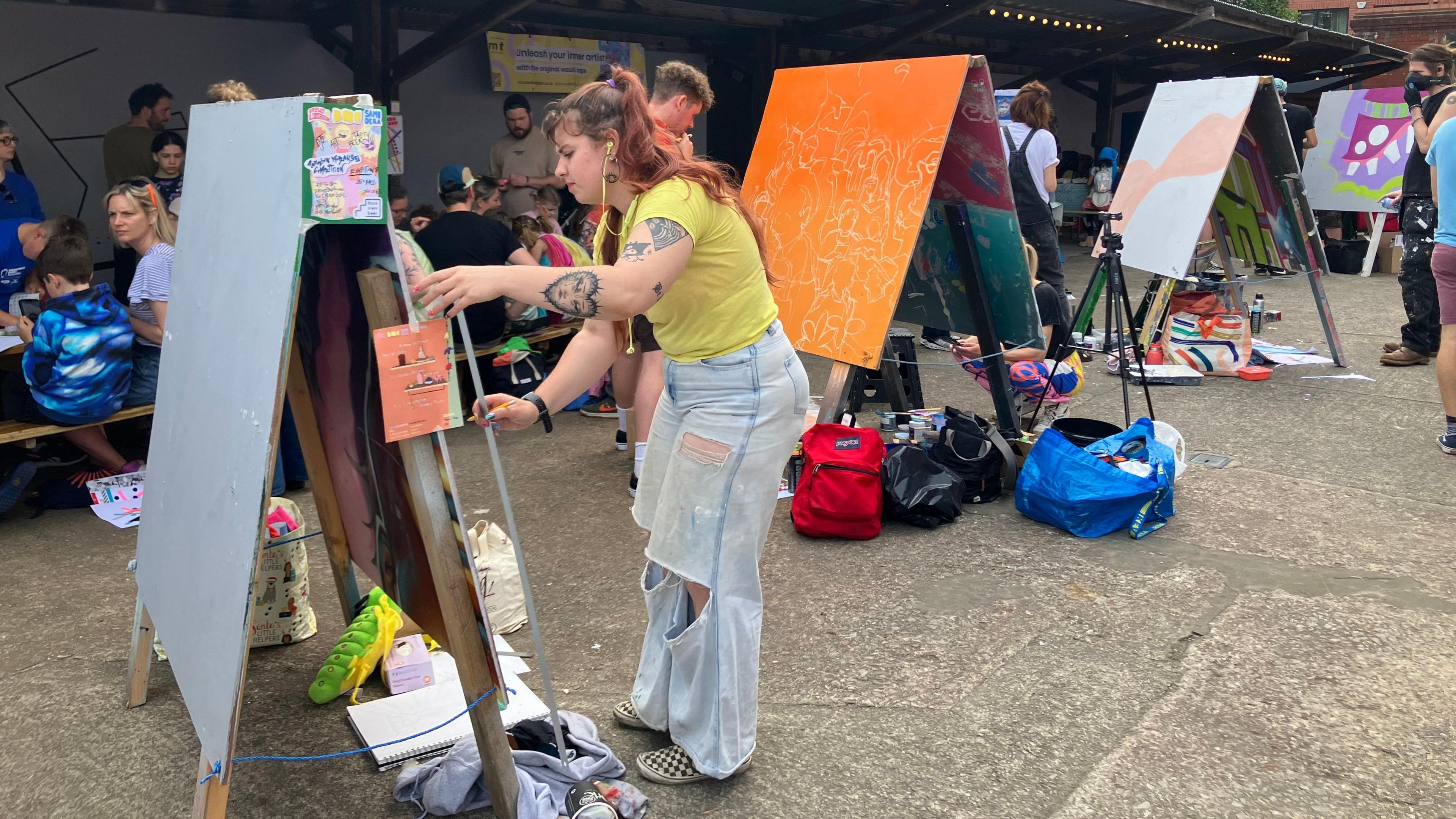 Artists and canvases outside the Tobacco Factory