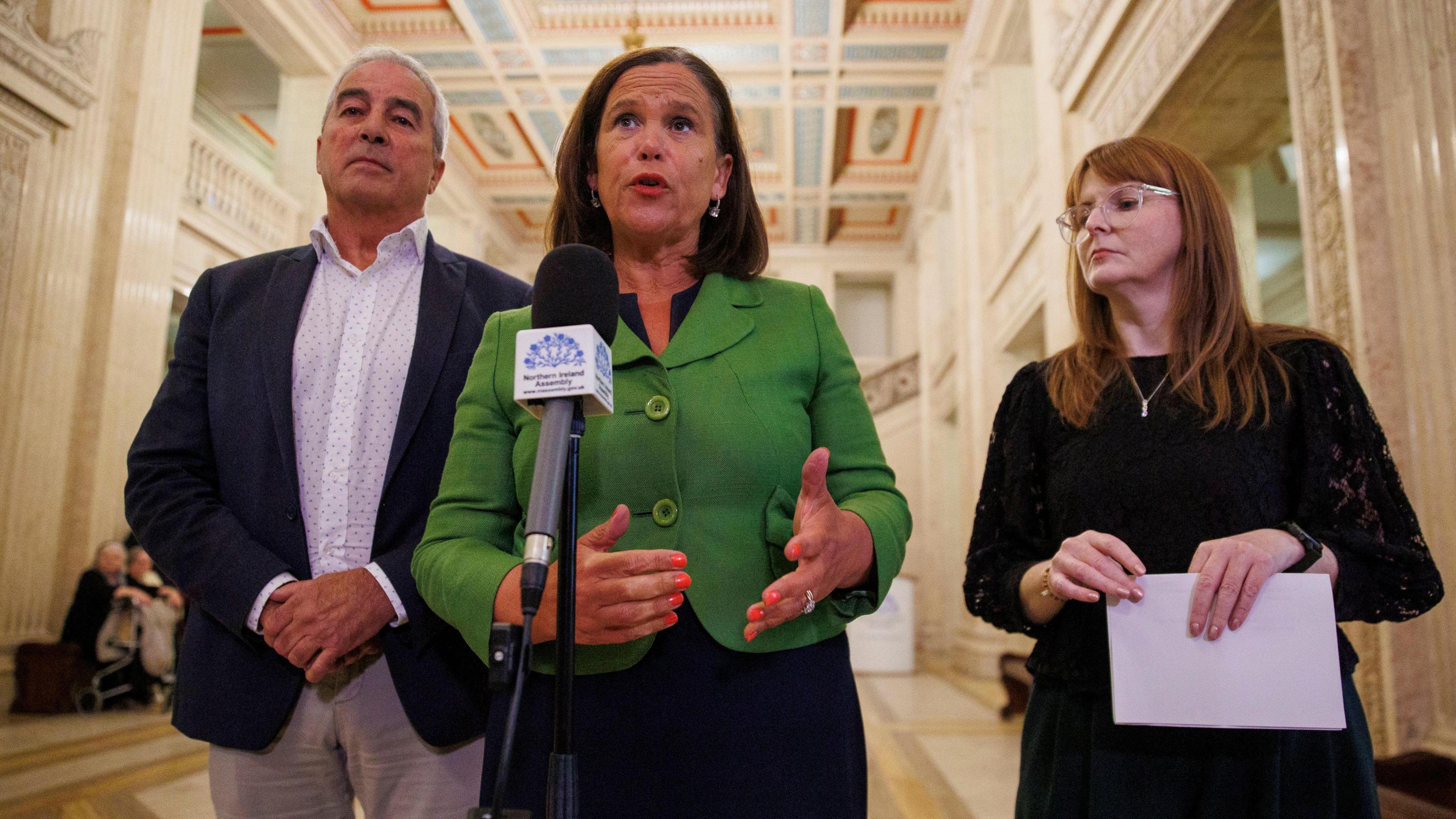 Sinn Féin leader Mary Lou McDonald (centre in a green blazer, black dress) with party colleagues Stormont Economy Minister Caoimhe Archibald and Pat Sheehan