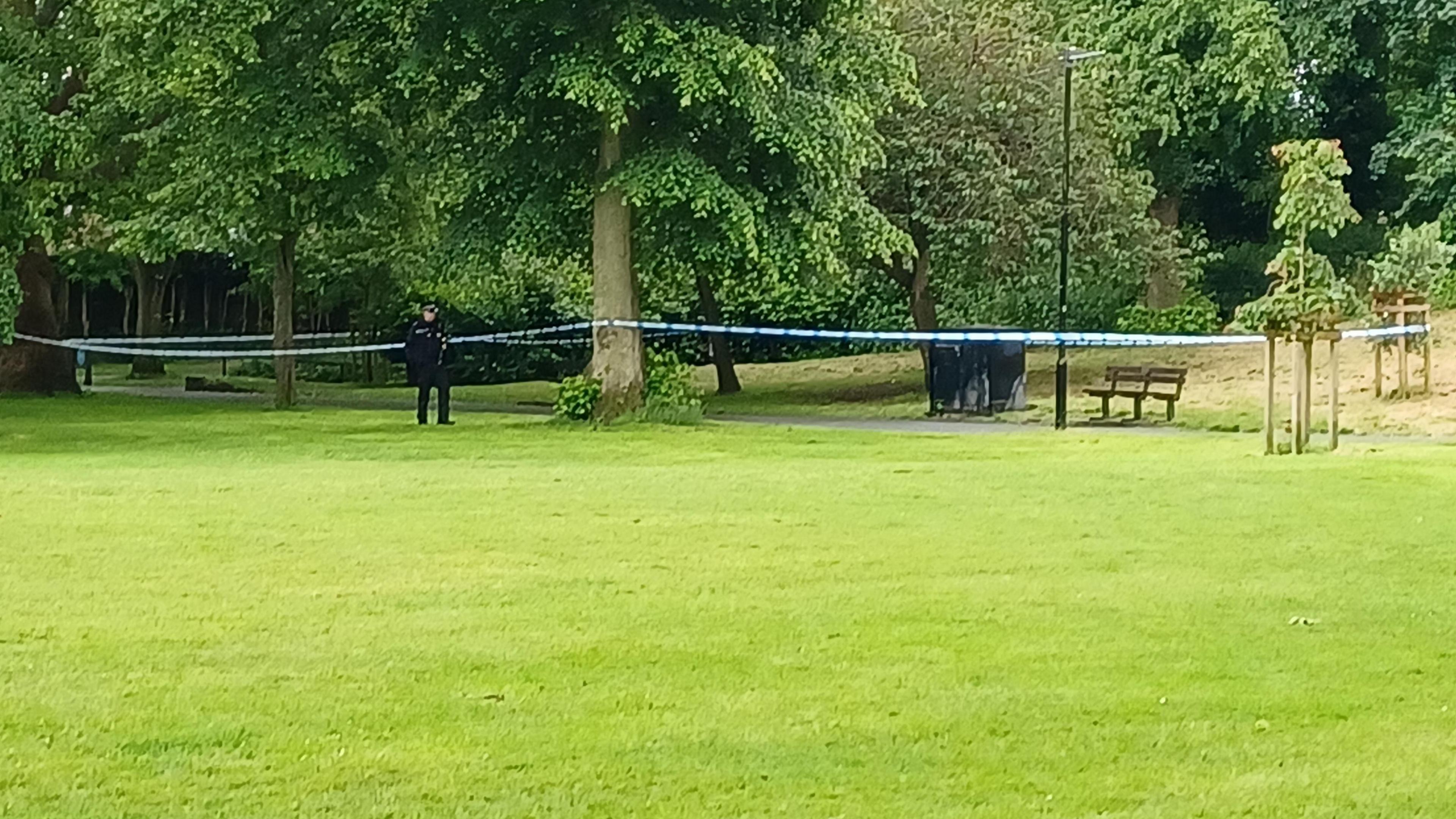 Police officer in Chapelfield Gardens stood next to a police cordon