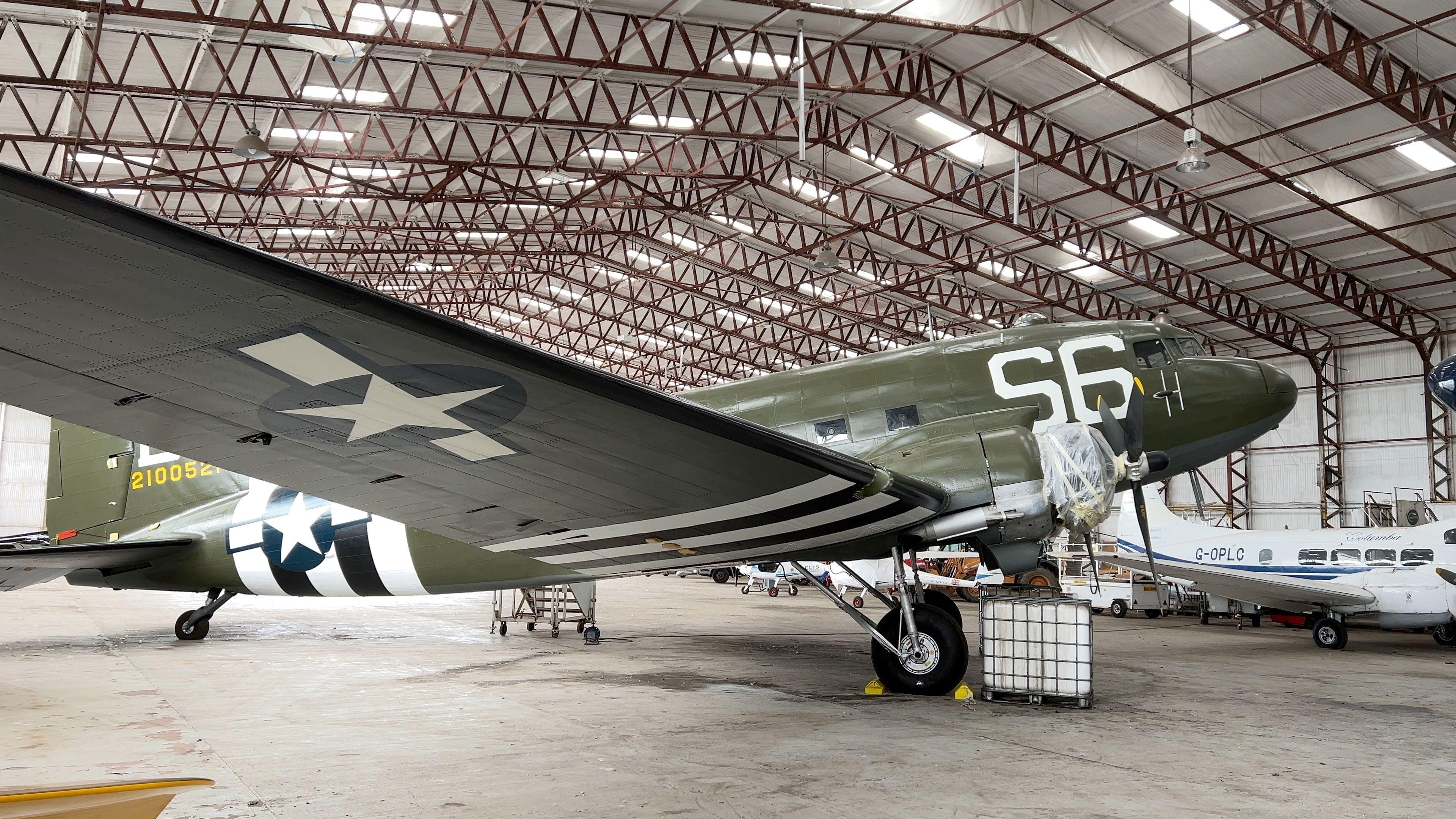 The former US transport plane christened Night Fright by its wartime crew stands inside an aircraft hangar.