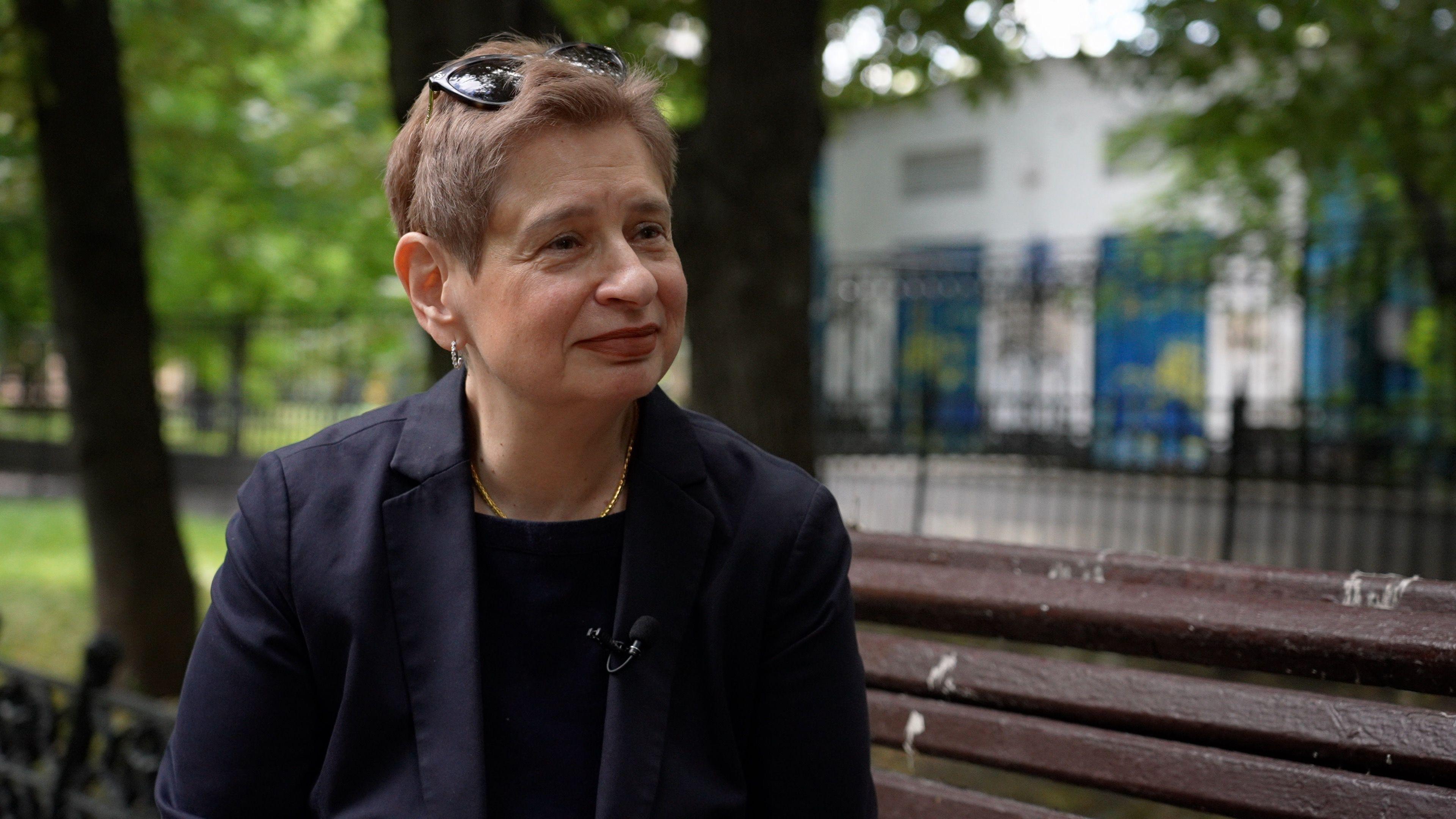 Nina Khrushcheva sits on a bench in Moscow as she speaks with the BBC