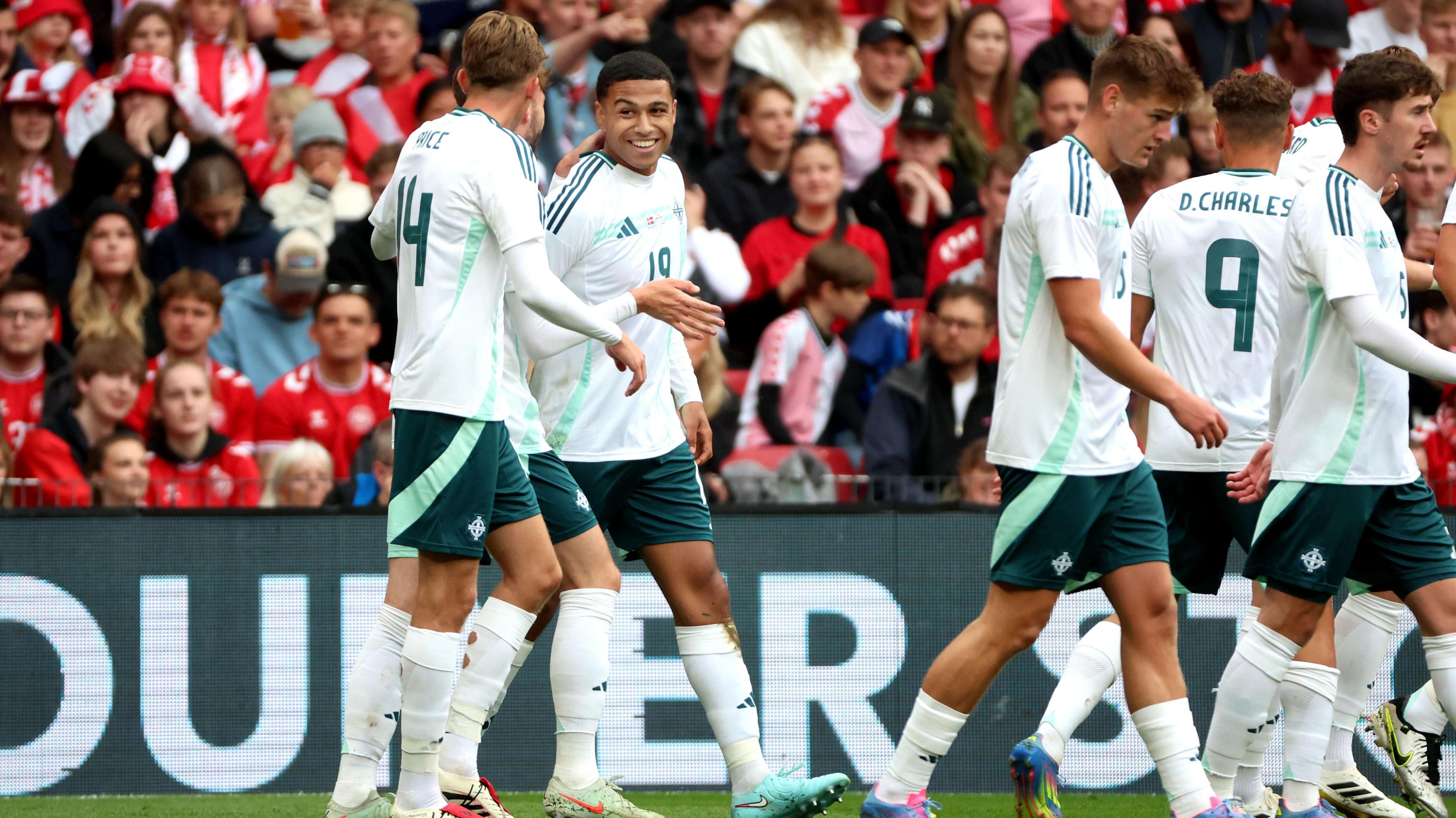 Shea Charles is congratulated by team-mates