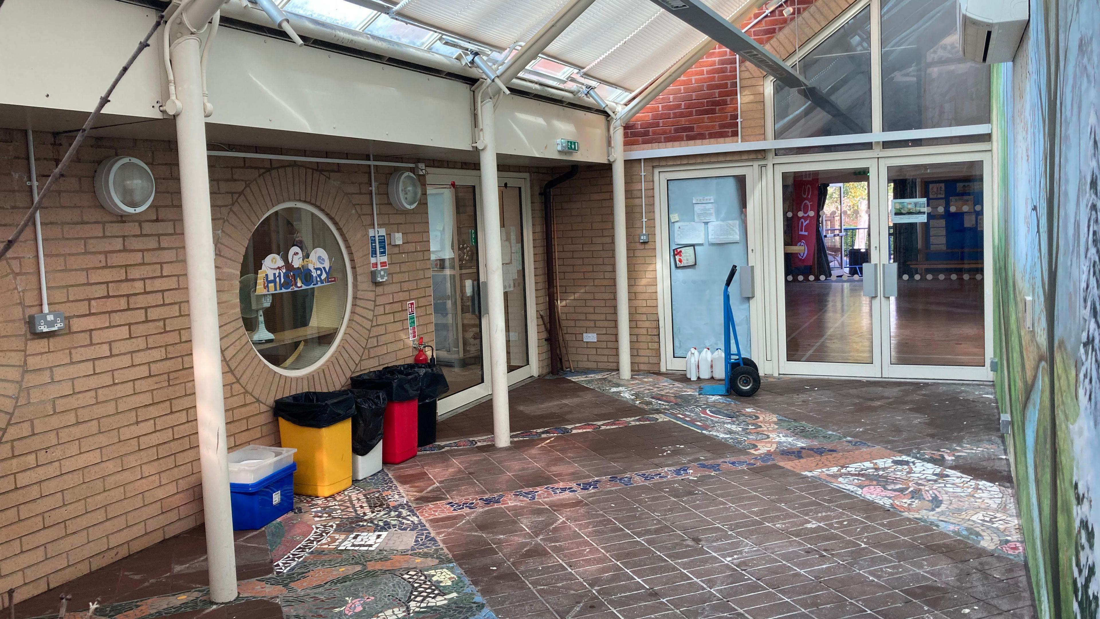 Tewkesbury C of E Primary School. Boxes and bins are against one of the walls. 