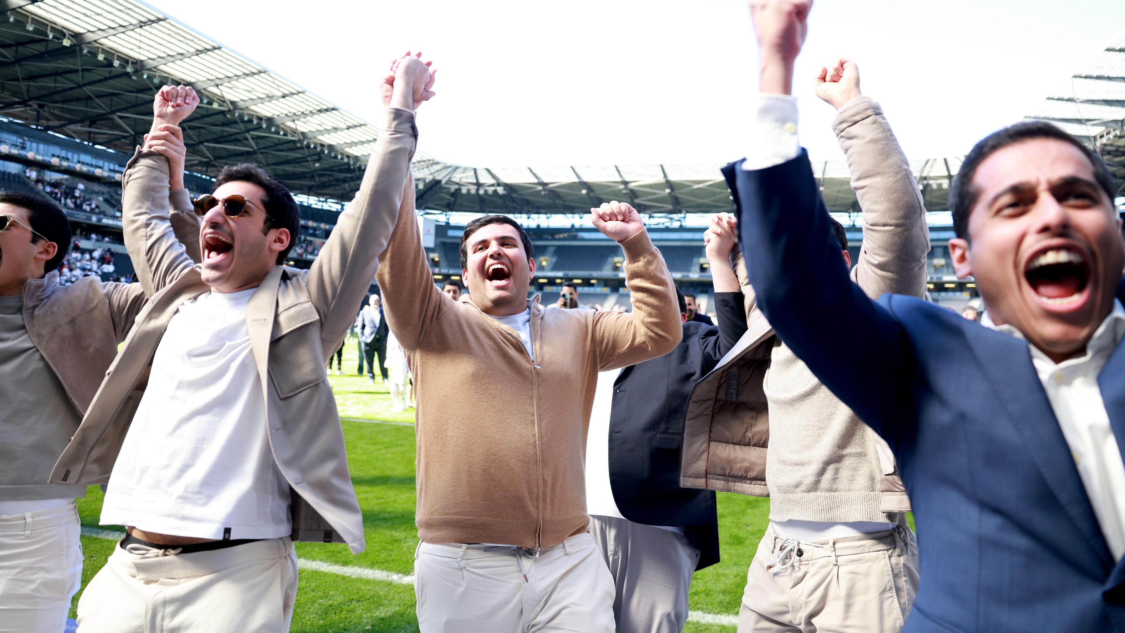 Milton Keynes Dons' owners celebrate their side's promotion to League One