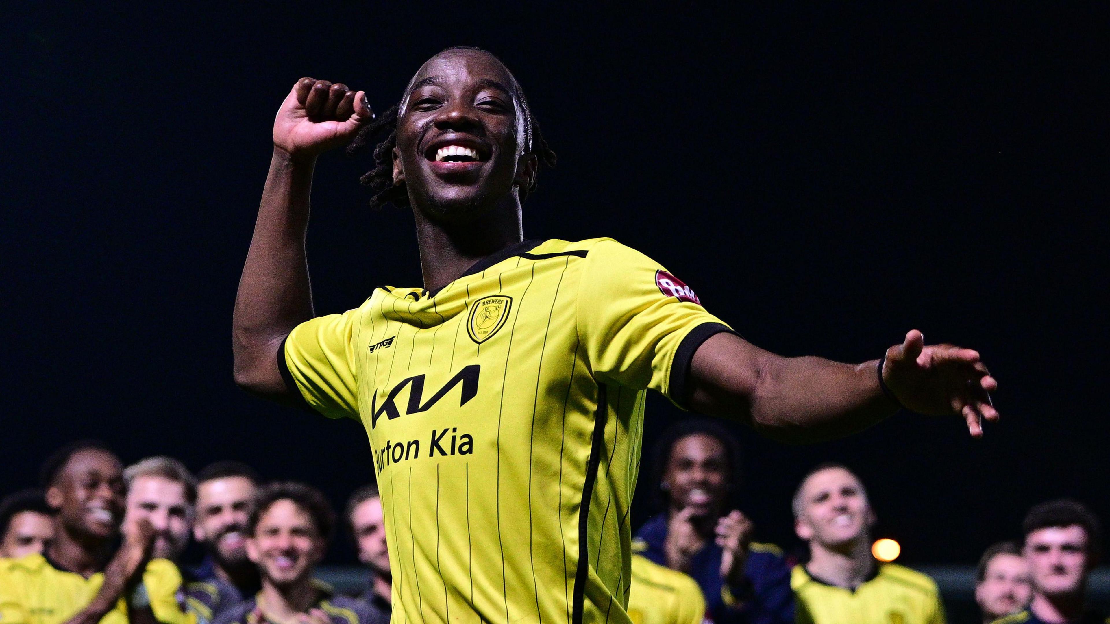 Burton Albion's Kegs Chauke celebrates the club staying up in League One.