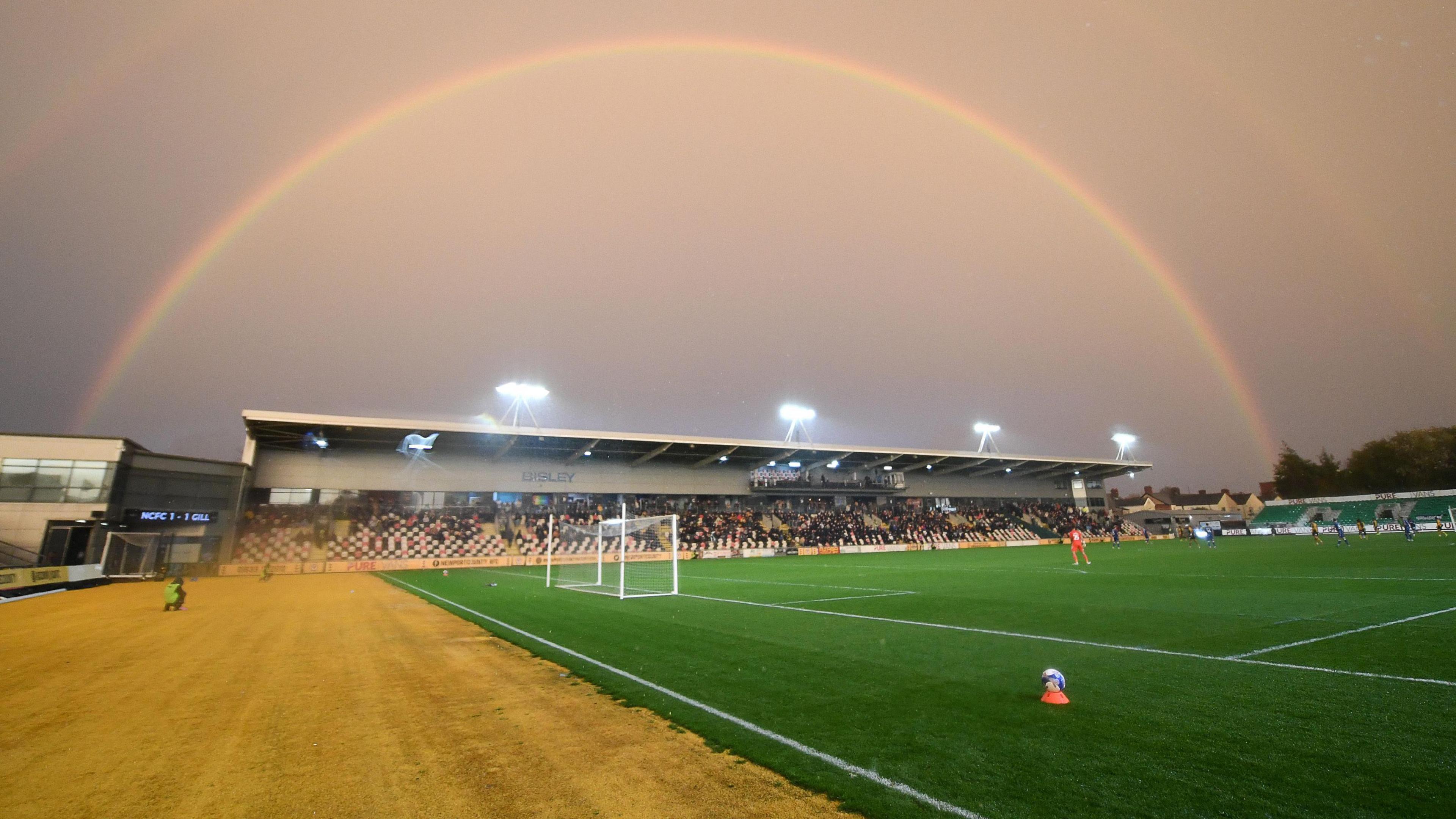 Newport County's ground Rodney Parade with a rainbow in the background.