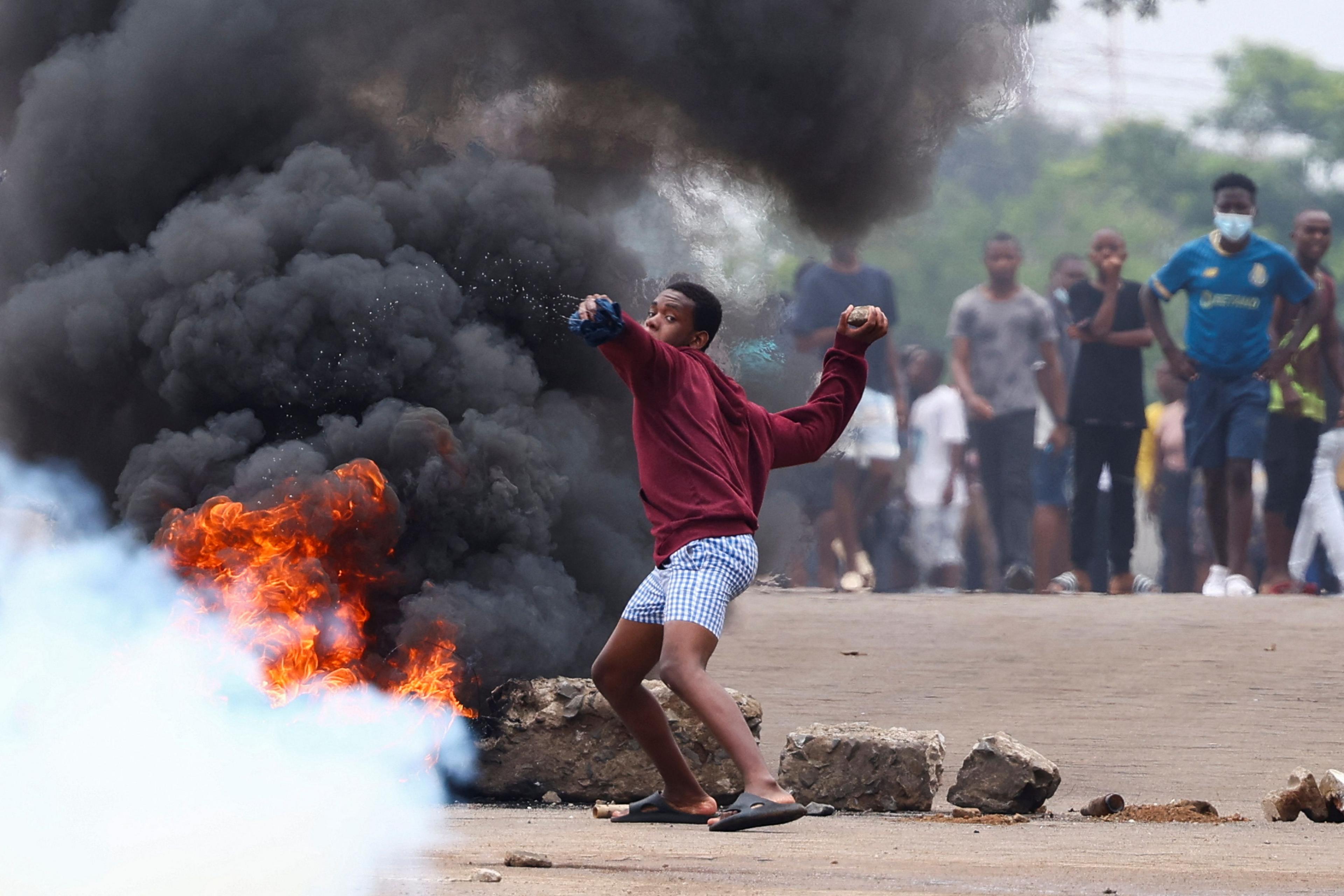 A young man throws a stone during a nationwide protest called by presidential candidate Venâncio Mondlane in Maputo, Mozambique - Monday 21 October 2024