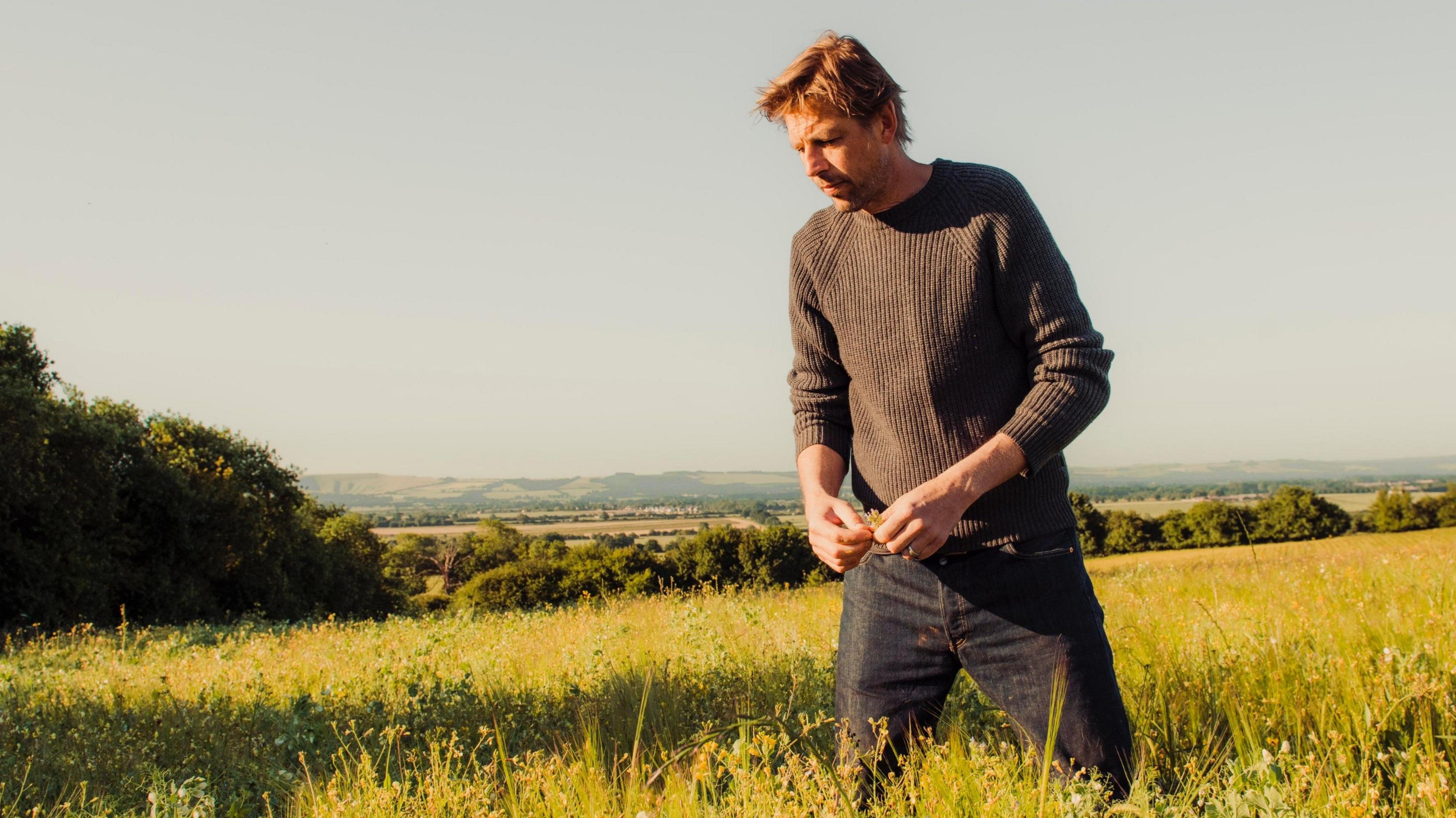 Andy Cato tending to a regeneratively farmed field.