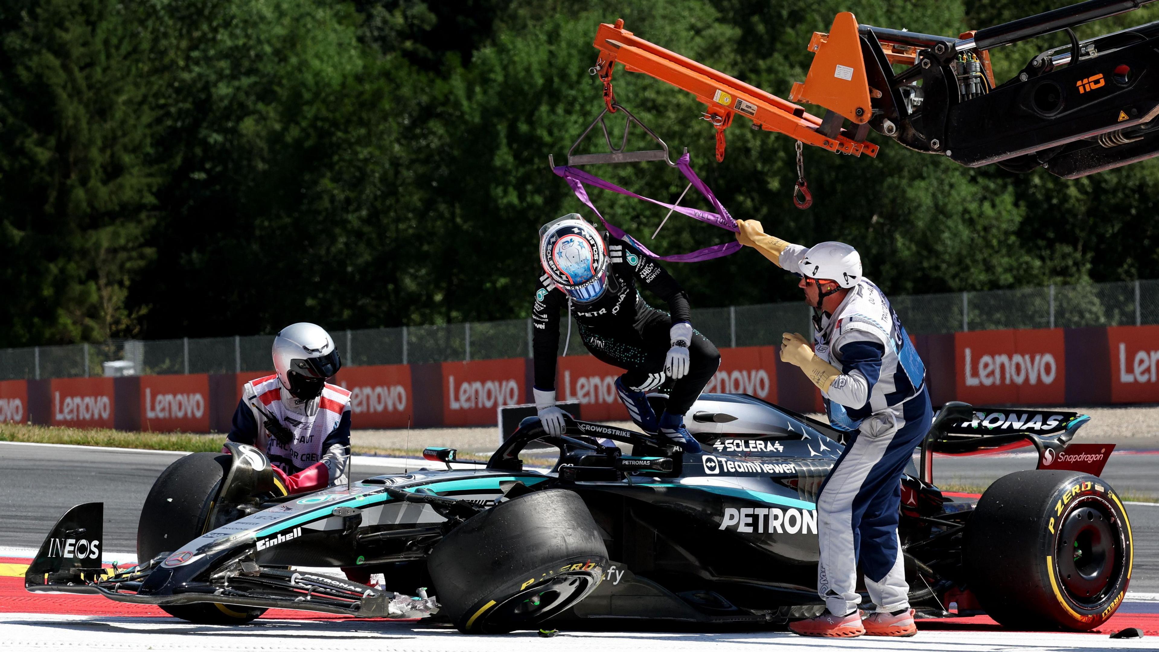 Kimi Antonelli climbs out of his damaged Mercedes after colliding with Max Verstappen