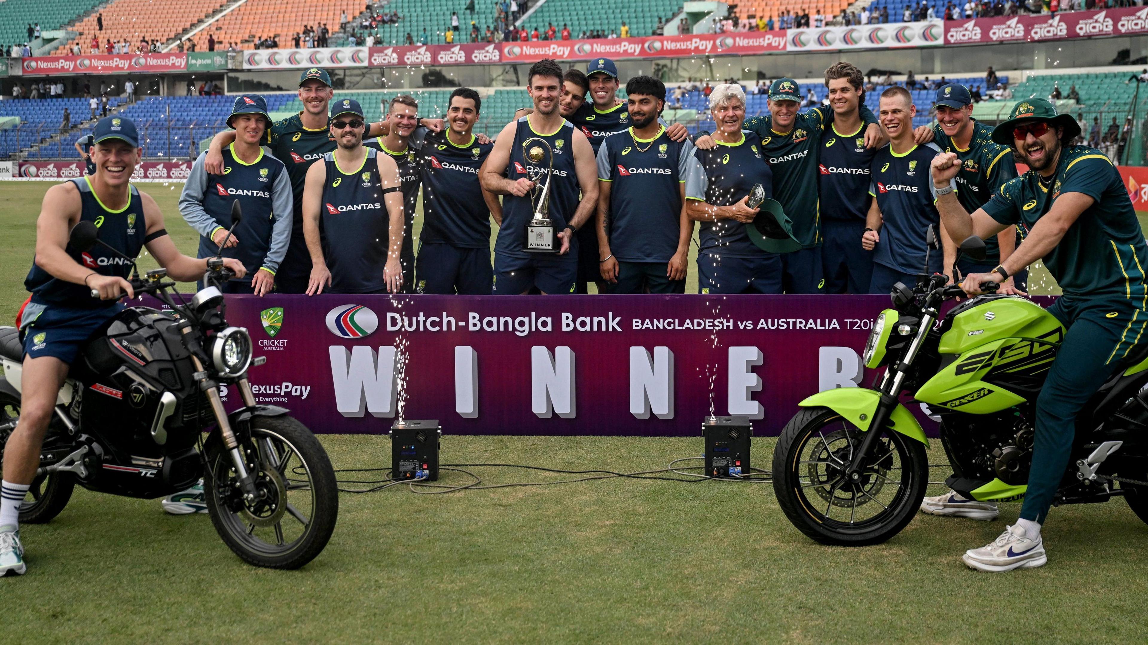 Australia celebrate with the T20 series trophy and a pair of motorbikes