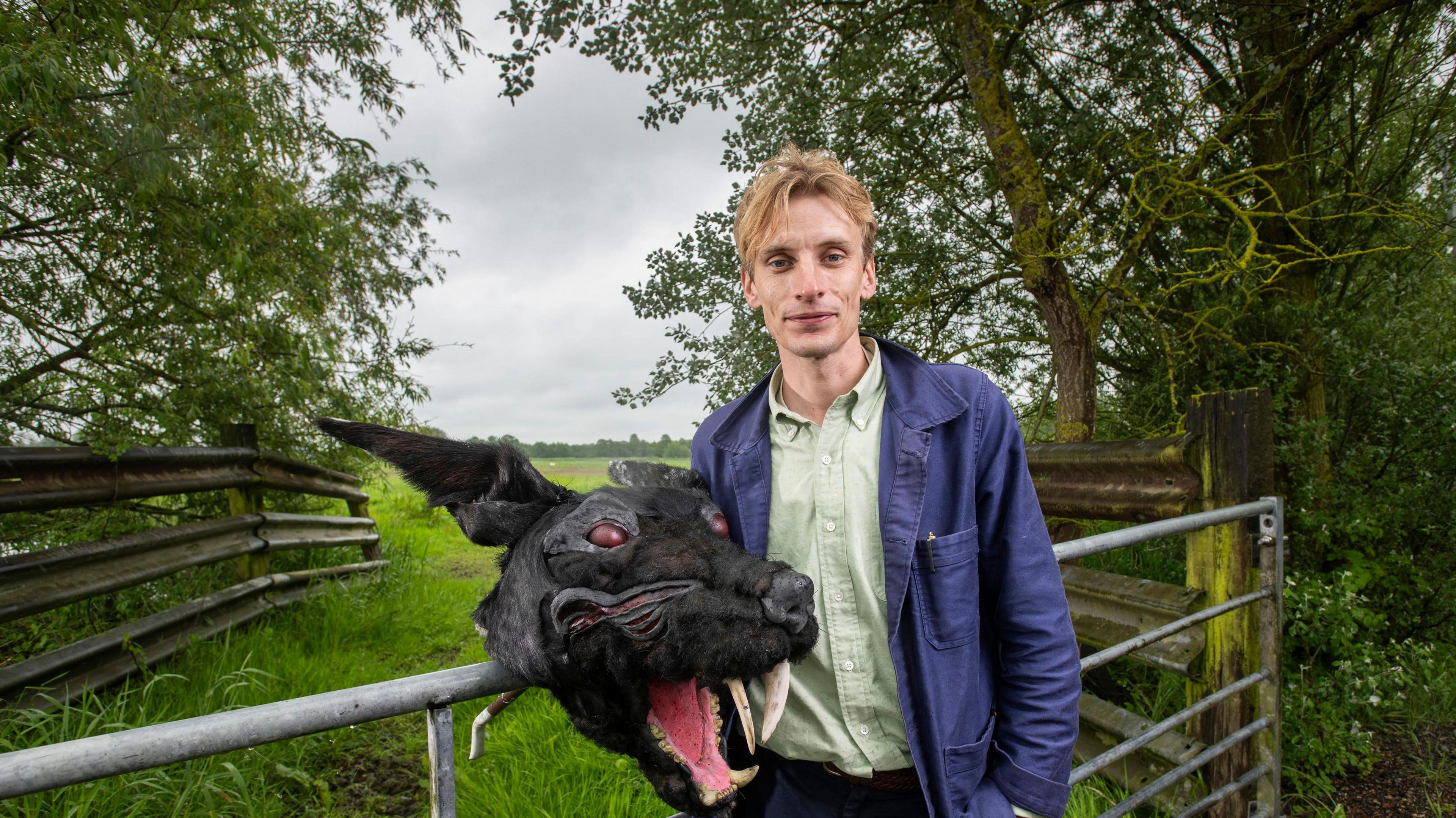 Charlie Cooper with a costume head of the Black Shuck, a ghostly dog that roams East Anglia 