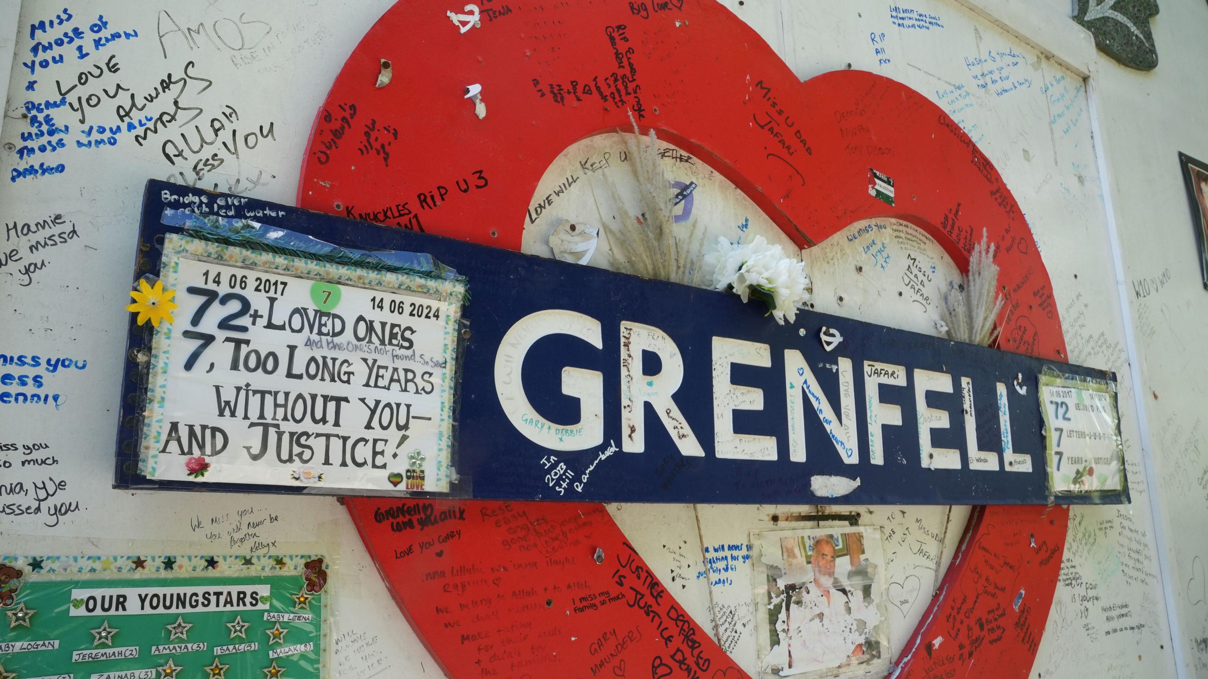 The Grenfell Memorial Wall in west London covered with handwritten messages honouring those who lost their lives in the fire. 