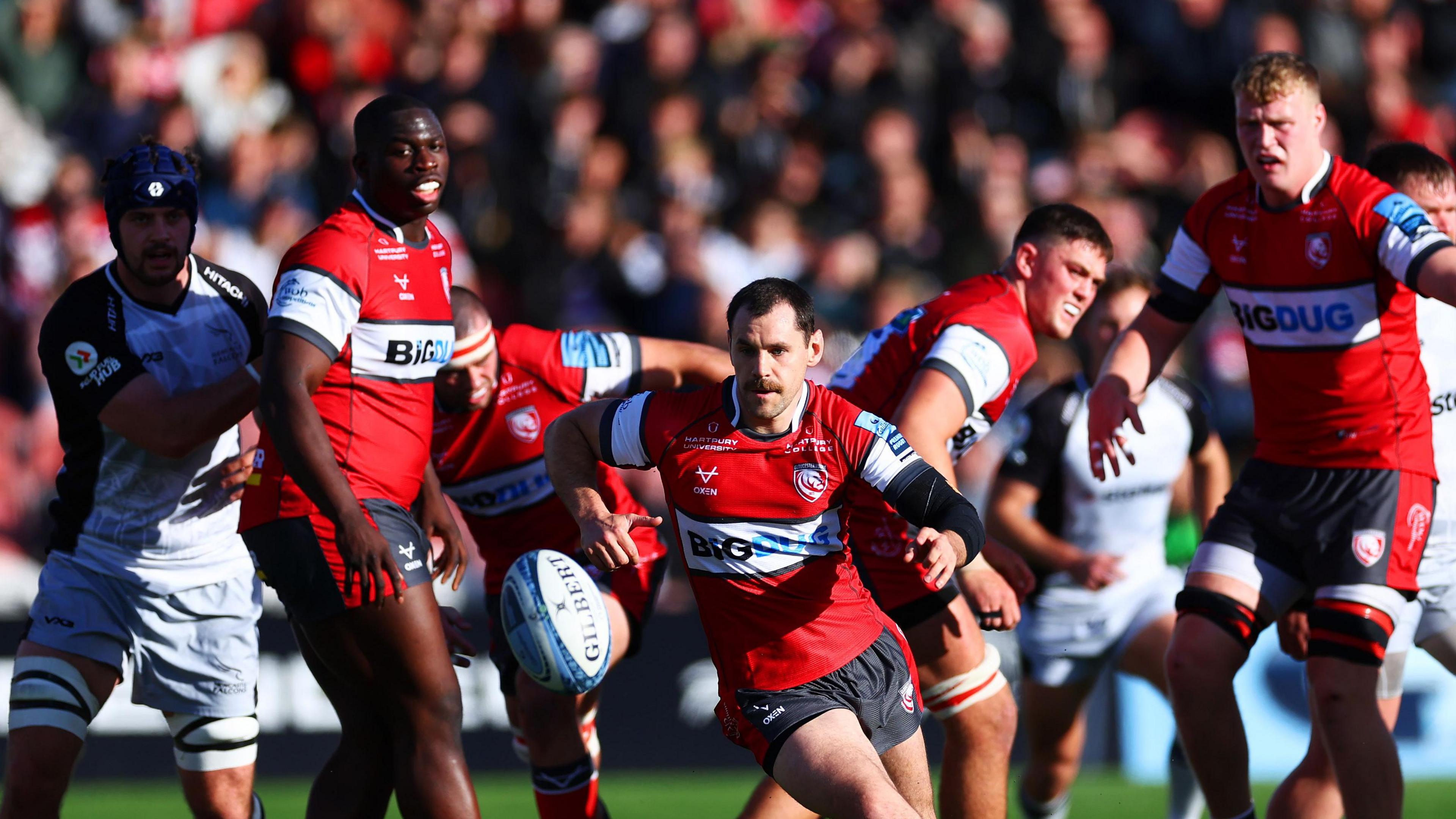 Gloucester and Wales scrum-half Tomos Williams chases the ball ahead of a few team-mates 