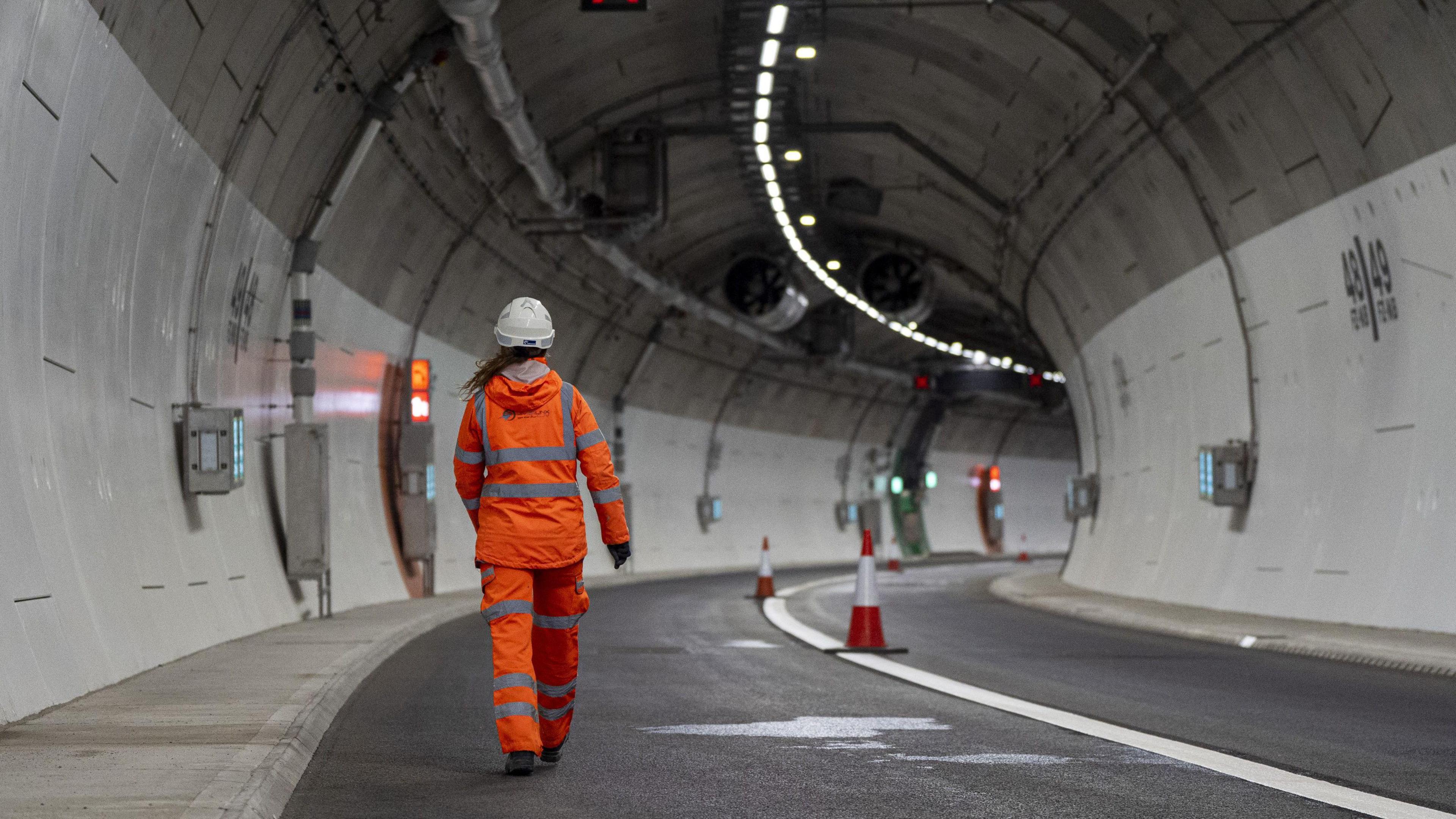 A worker in high vis walking through the newly built Silvertown Tunnel in east London before it opens to traffic.  