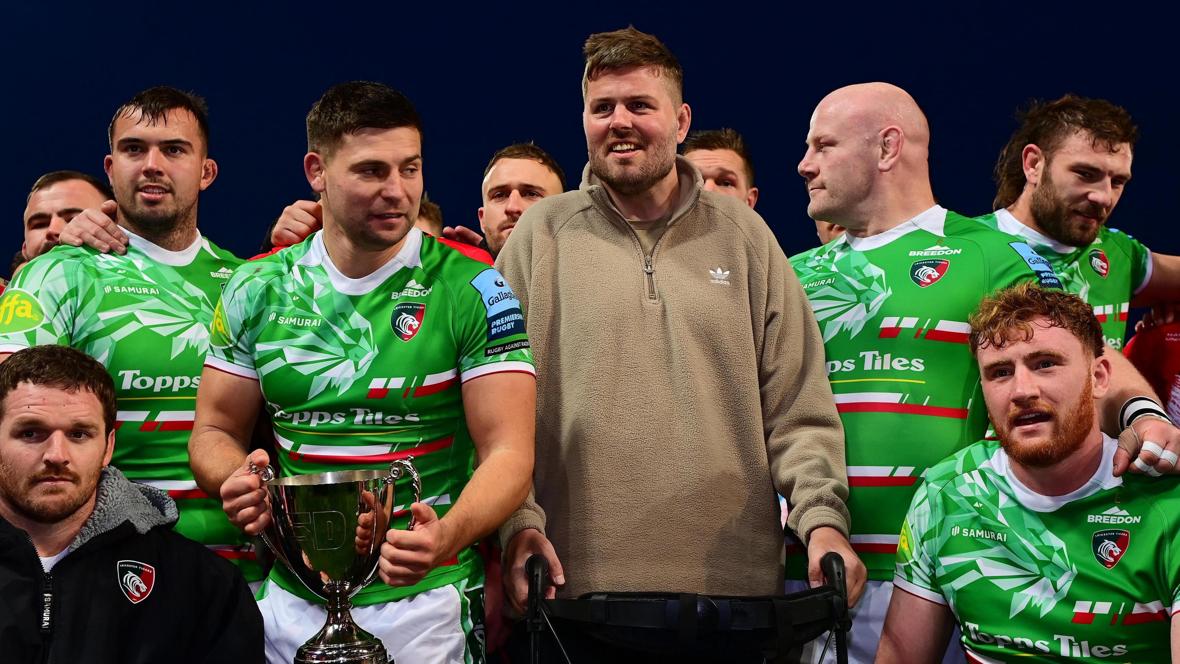 Ed Slater with Leicester players after they claimed the trophy named in his honour