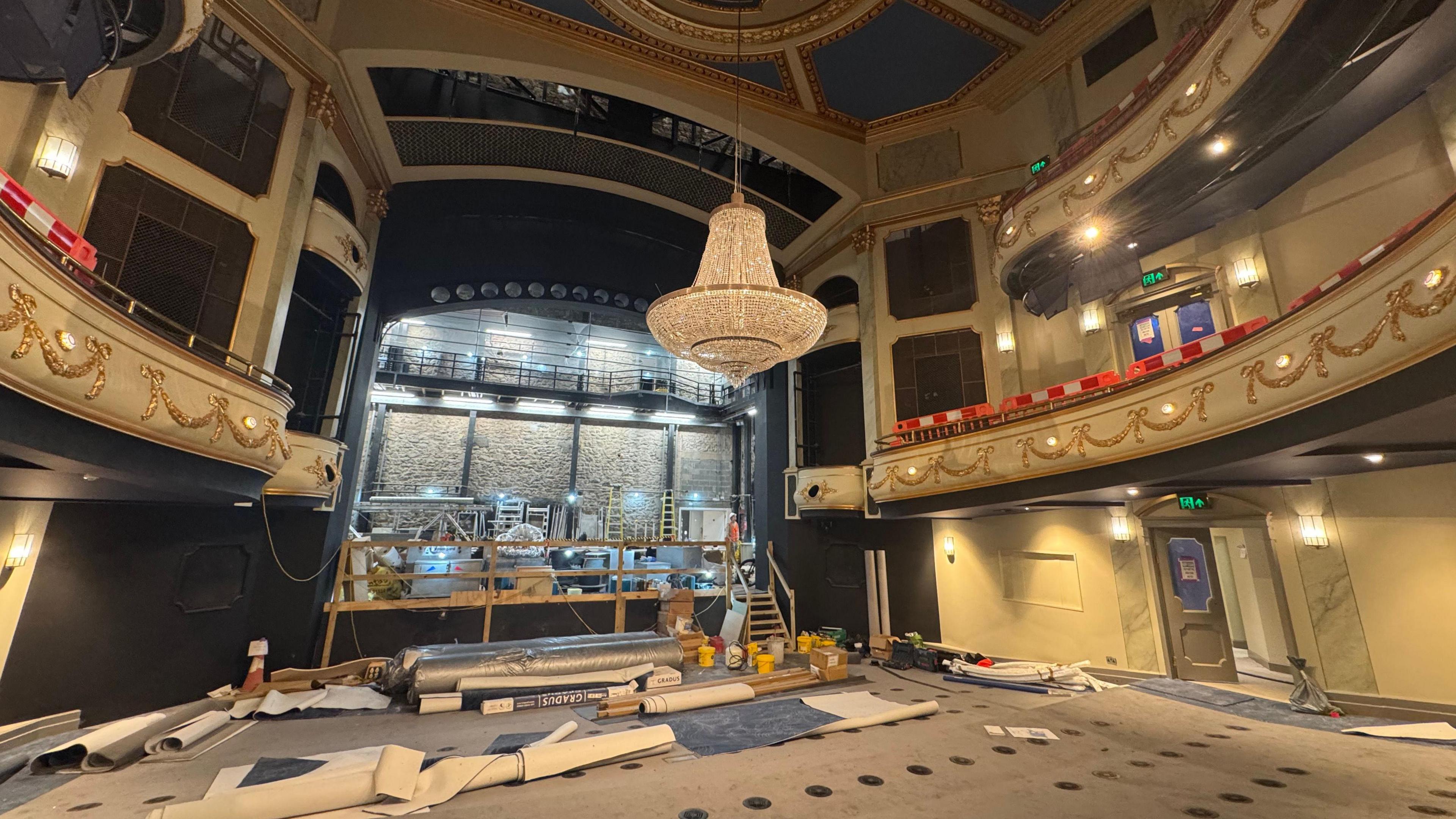 Progress pictures of Jersey Opera House refurbishment. The stage is partially dismantled with materials below it.